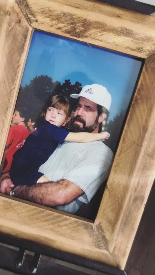 A father and daughter hugging each other. A picture of a daughter who lost her father