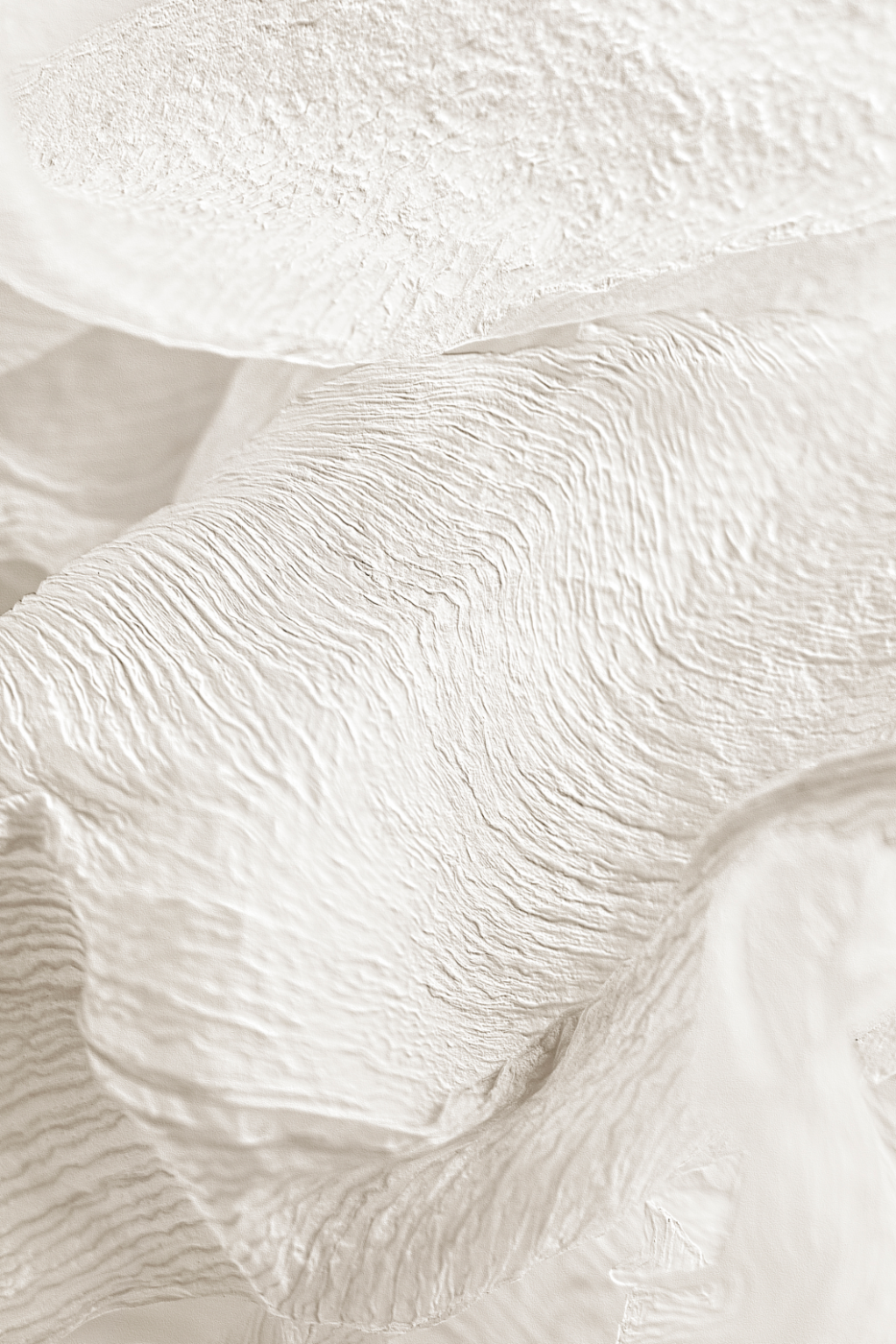 Close-up of textured white paper or fabric with rippled surface.