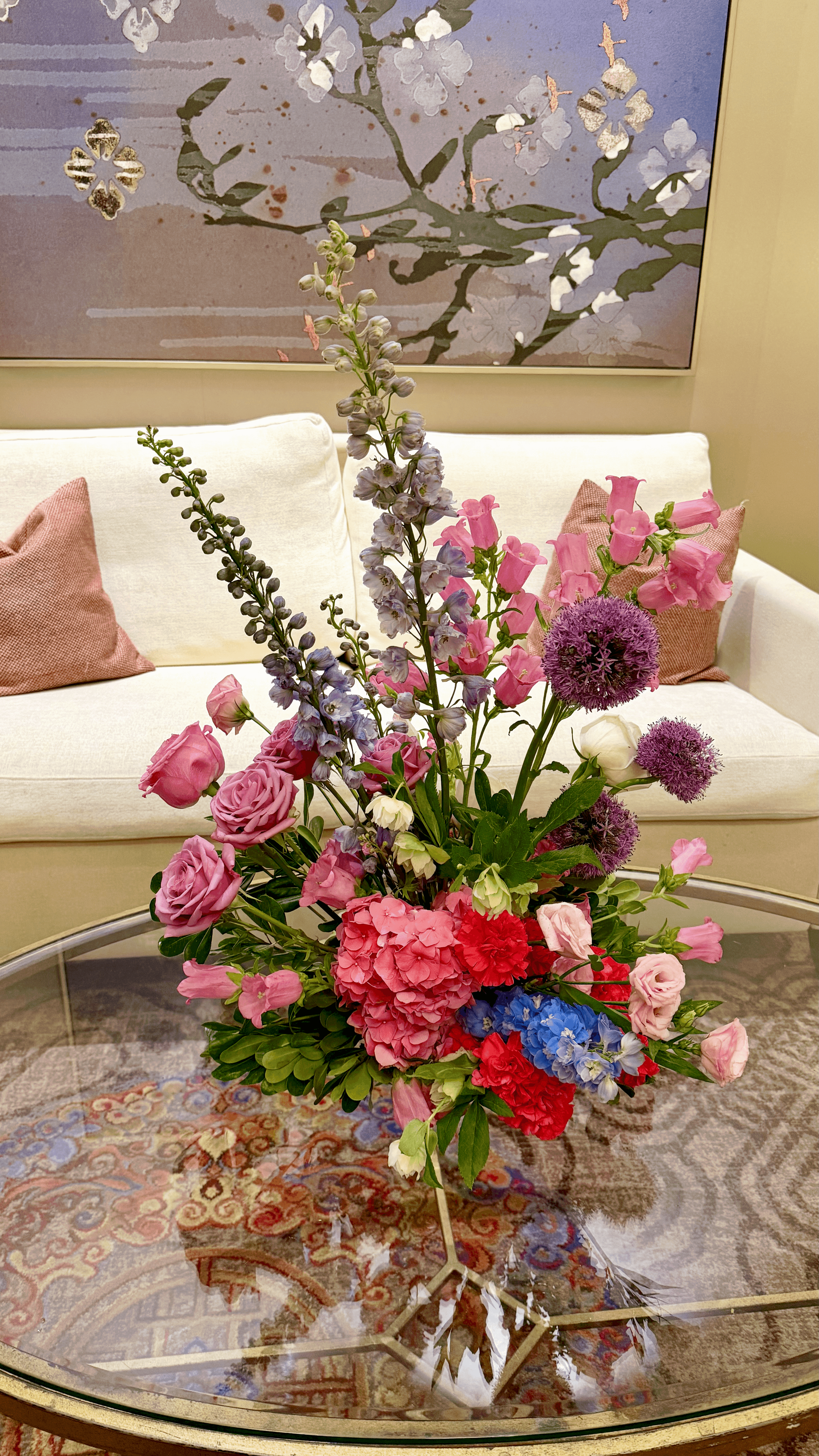 a vibrant pink, purple, and colorful lounge floral arrangement sitting on a table at The Salamander in Washington, DC