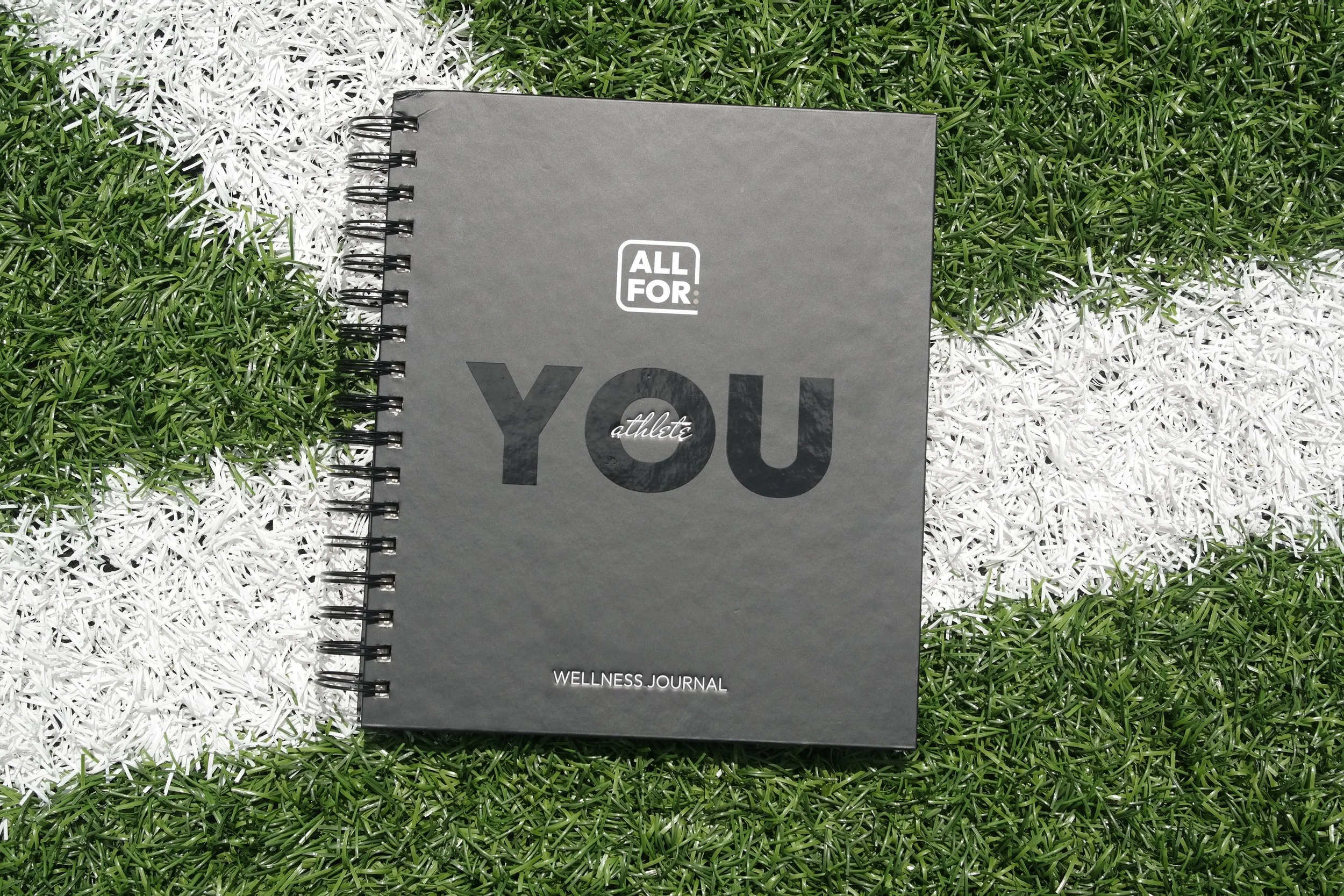 The Athlete in You Journal on field.