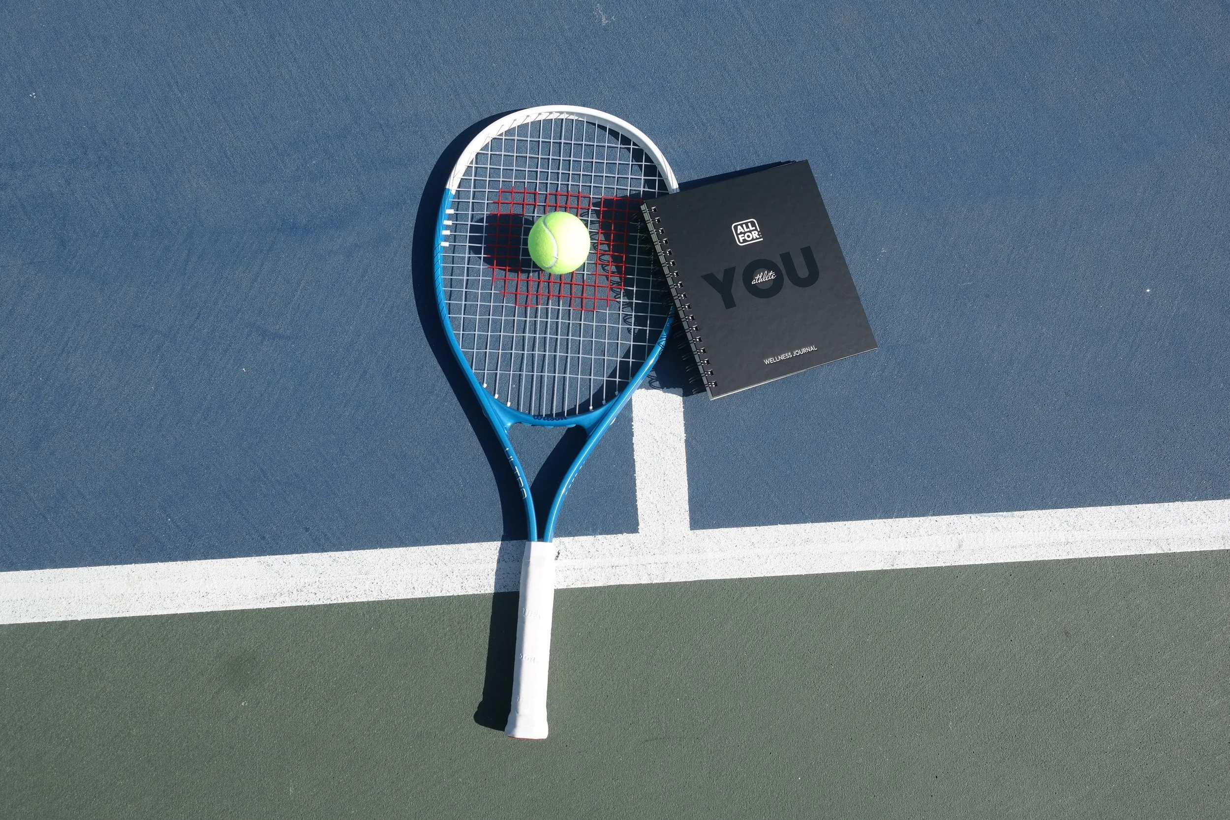 tennis racket, ball, and journal