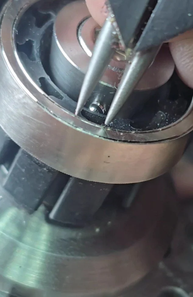 Close-up of precision tools for hand engraving working on a white gold wedding or engagement band.