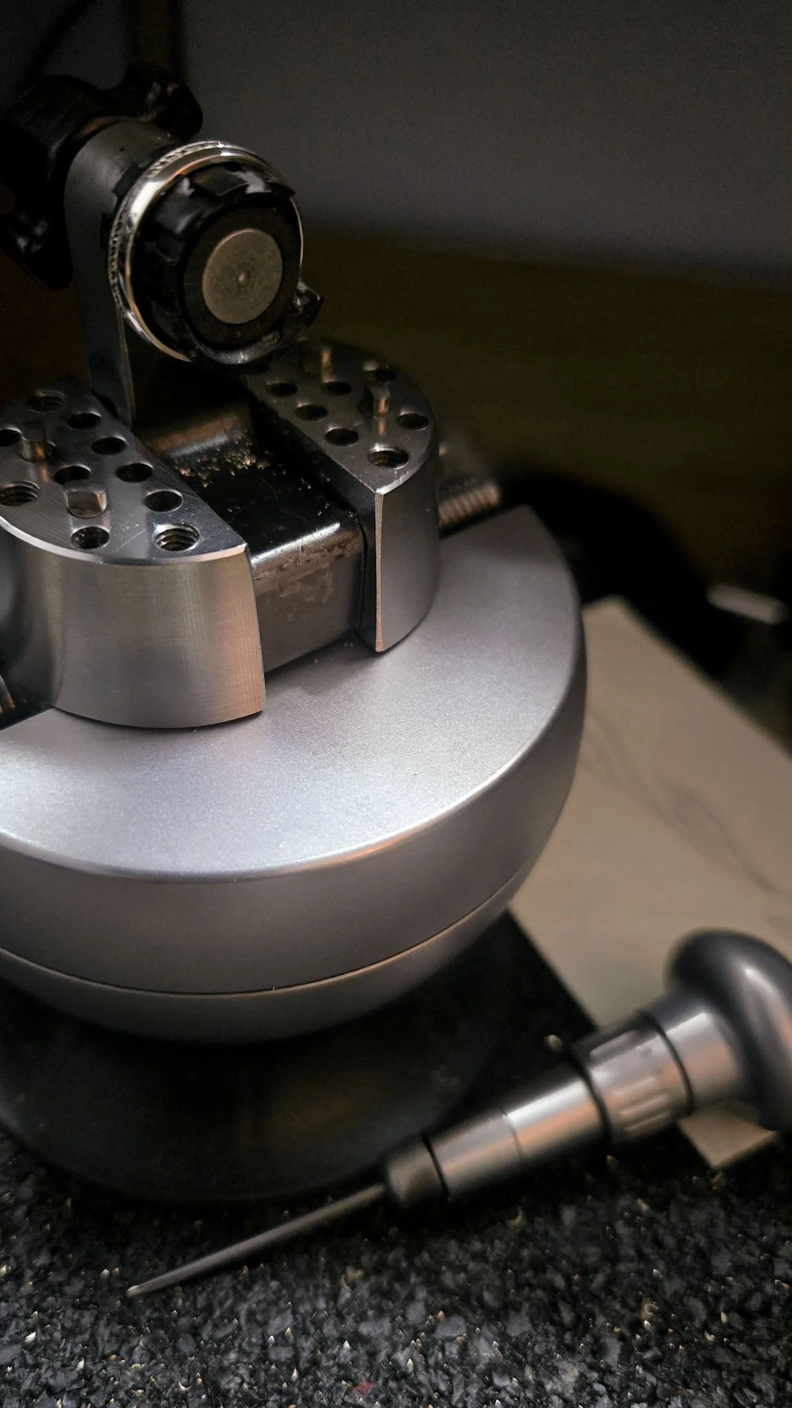 A hand engravers bench and tools and silver wedding ring