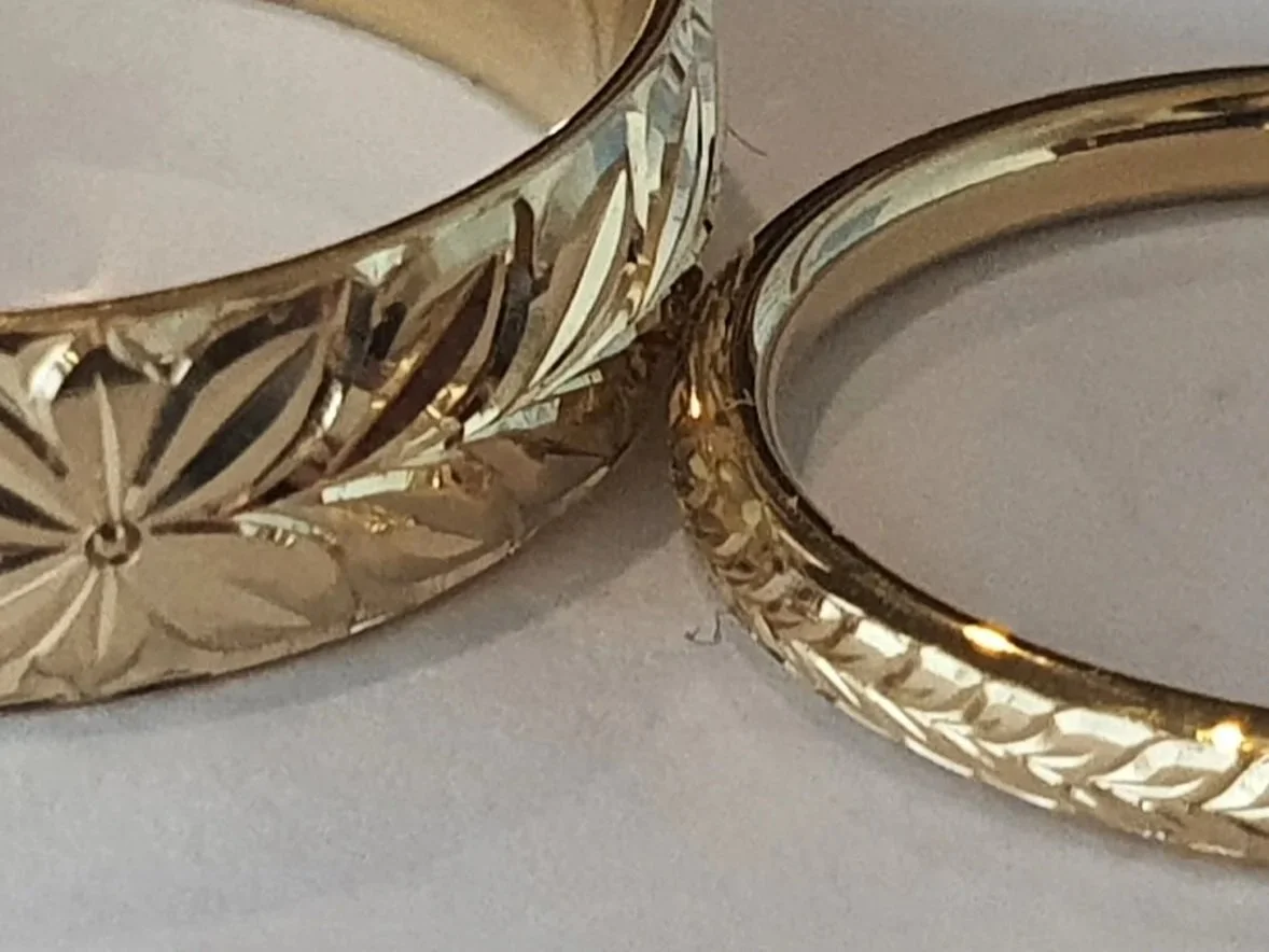 A hand engraved gold scroll band
