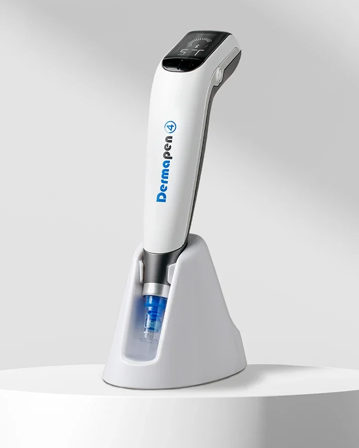 A Dermapens4 medical device on a charging stand, used for skin treatments, with digital display and blue light in a clinical setting.