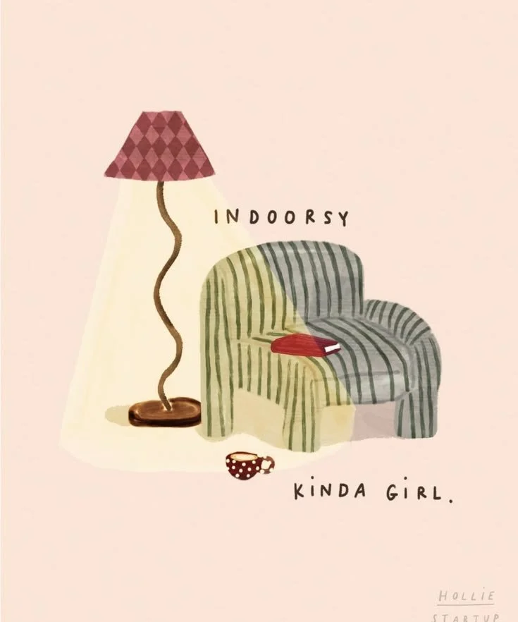 A cozy living room illustration with a striped green armchair, a red book on it, a polka-dotted mug on the floor, and a pink-checkered lamp, with the text 'Indoor so Kinda Girl'.