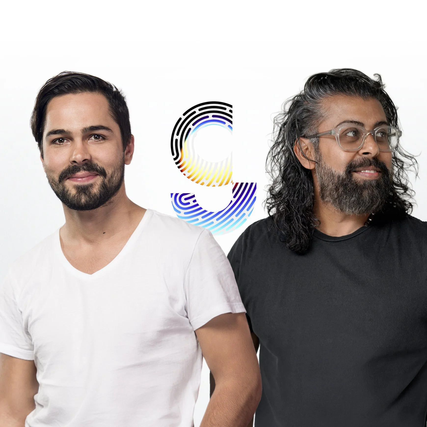 Two men standing side by side against a white background, one with short dark hair and a beard wearing a white t-shirt, and the other with long hair or gray hair, glasses, and a beard wearing a black t-shirt. A large colorful graphic with the letter 'C' and fingerprint patterns is behind them.