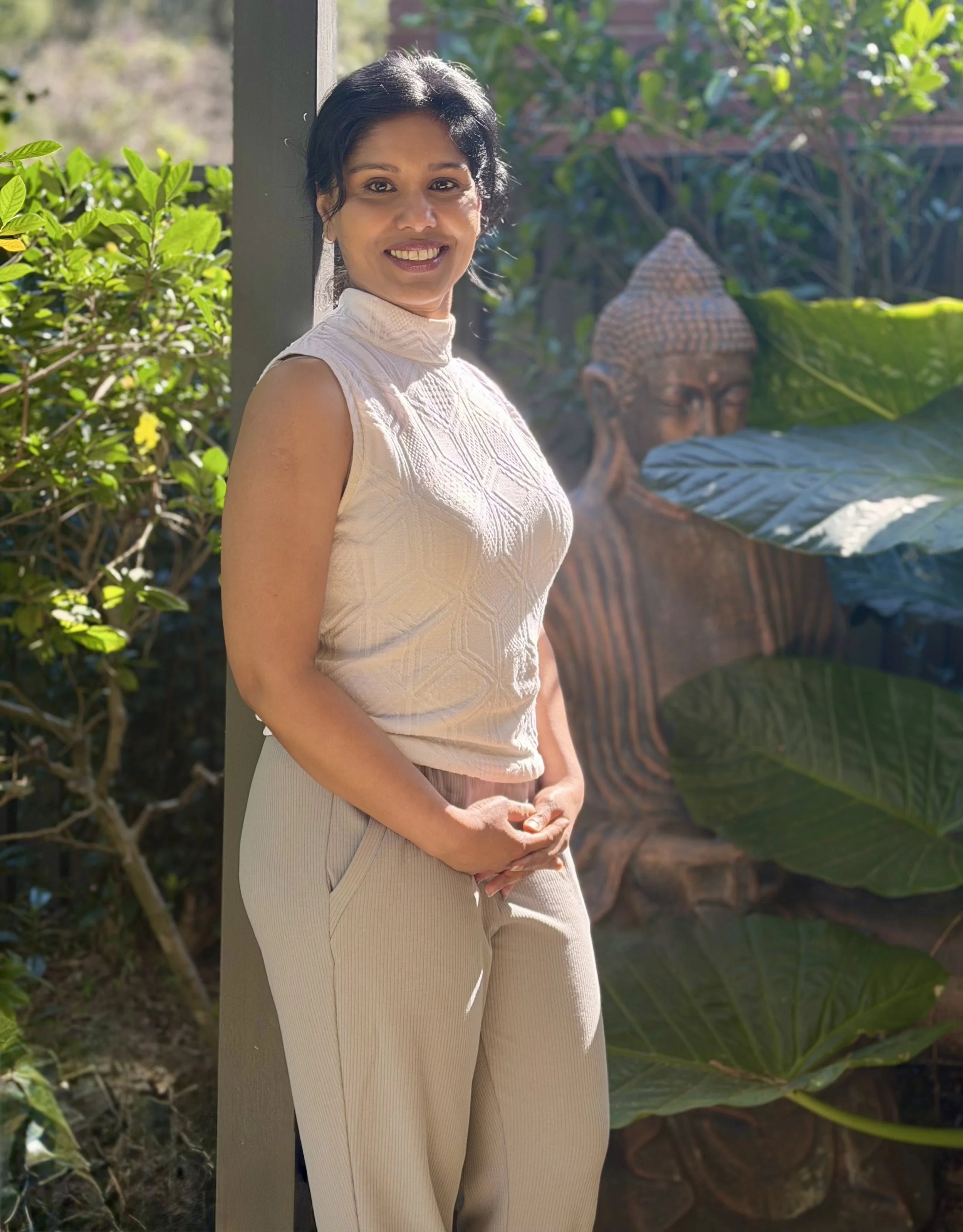 Corporate yoga and mindfulness instructor from Swan Wellness holding a yoga mat in a Sydney office setting.