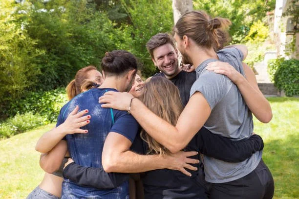 Employees participating in a relaxed outdoor team building workplace yoga class as part of a Swan Wellness program in Sydney