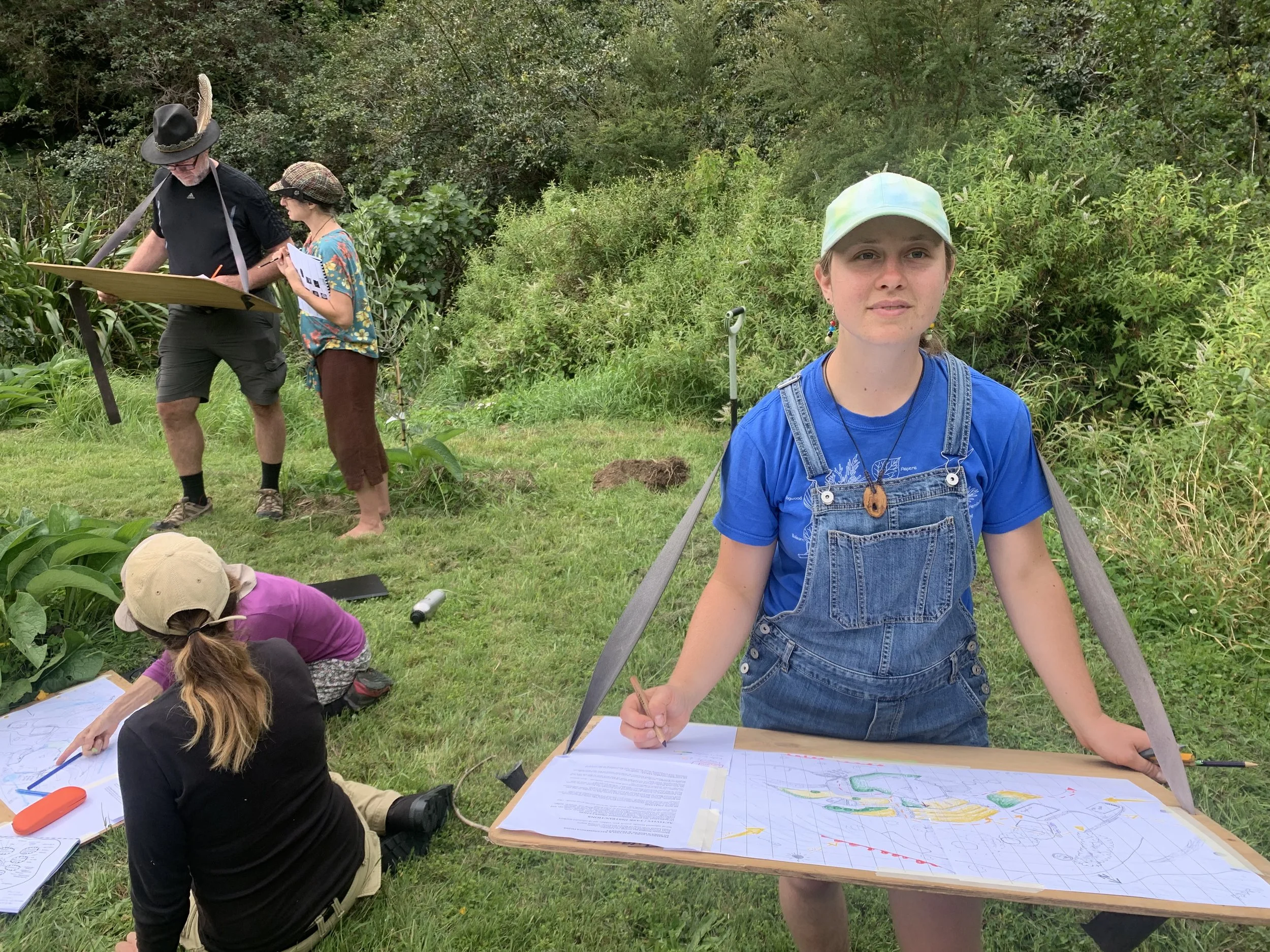 Woman standing in field with a design board
