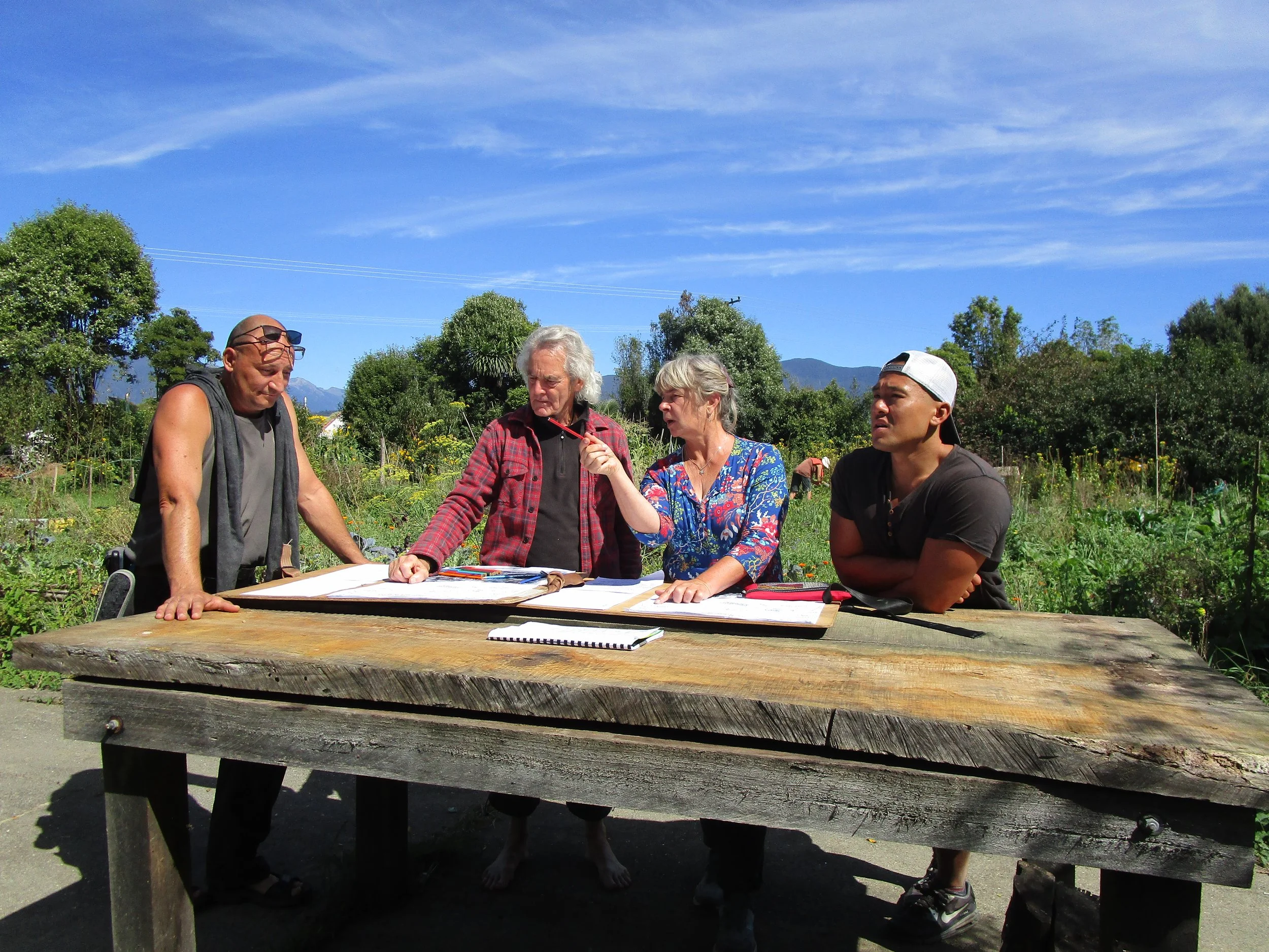 Group of students around a table with blue sky above