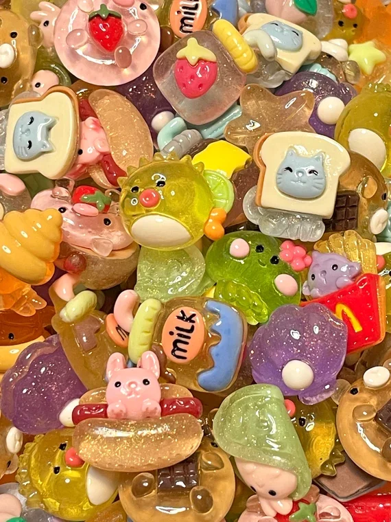 Assorted colorful candies, including novelty shaped gummies and chocolates, featuring cute animal designs and playful shapes.