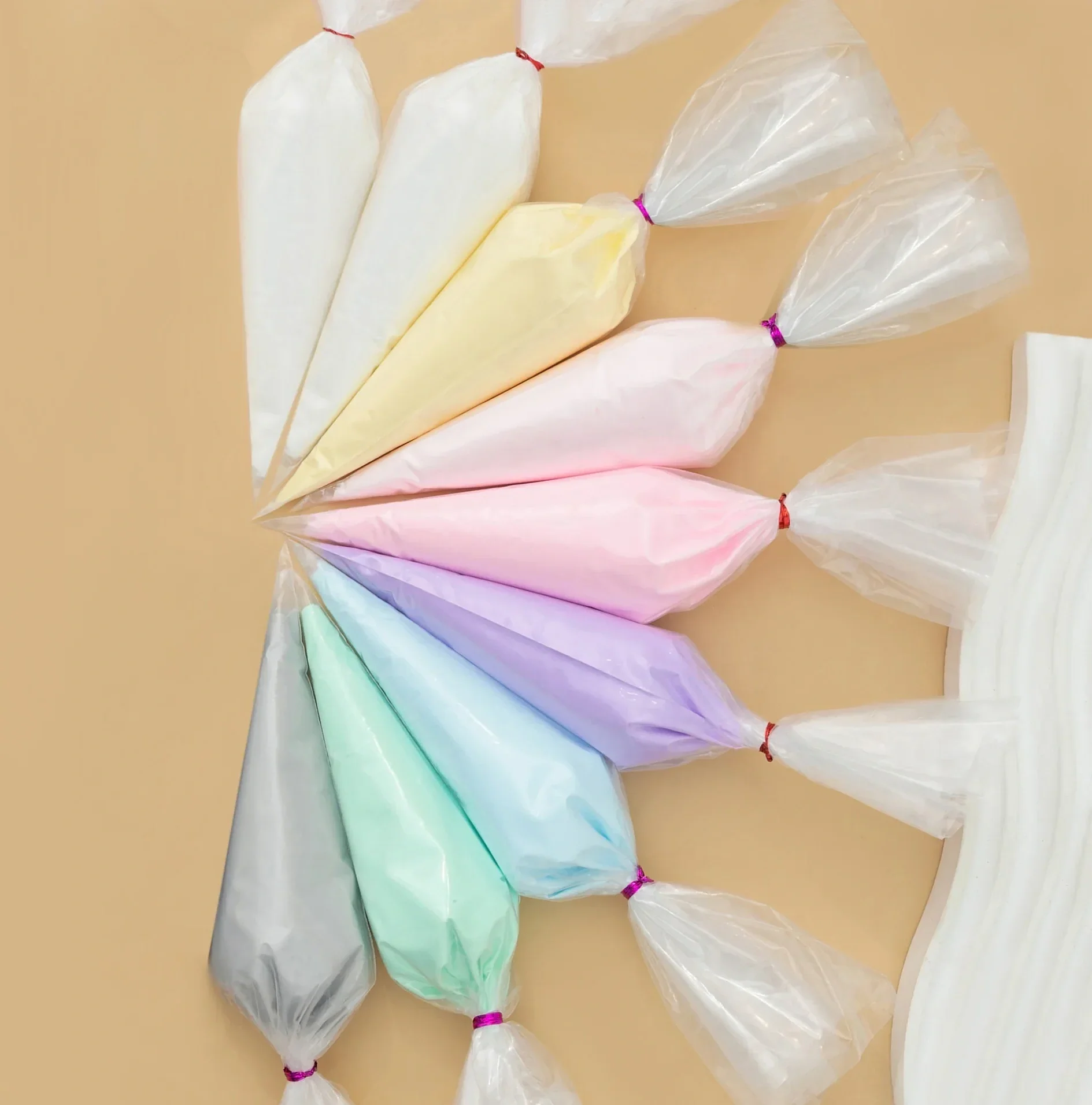 Colorful cotton candy bags arranged on a beige surface.