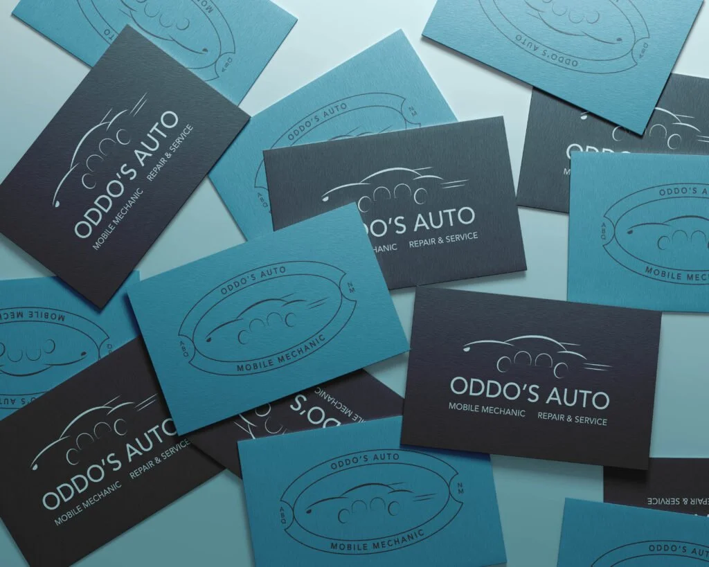 Scattered branded cards featuring the Oddo’s Auto logo