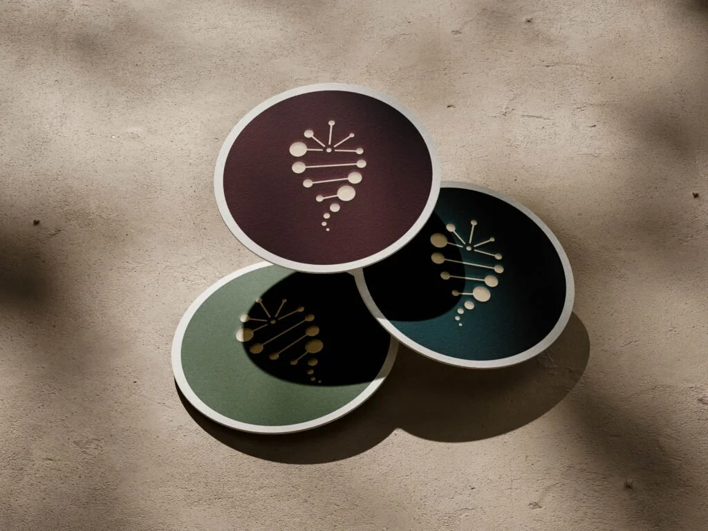 Coasters featuring a DNA-inspired logo for a cannabis company