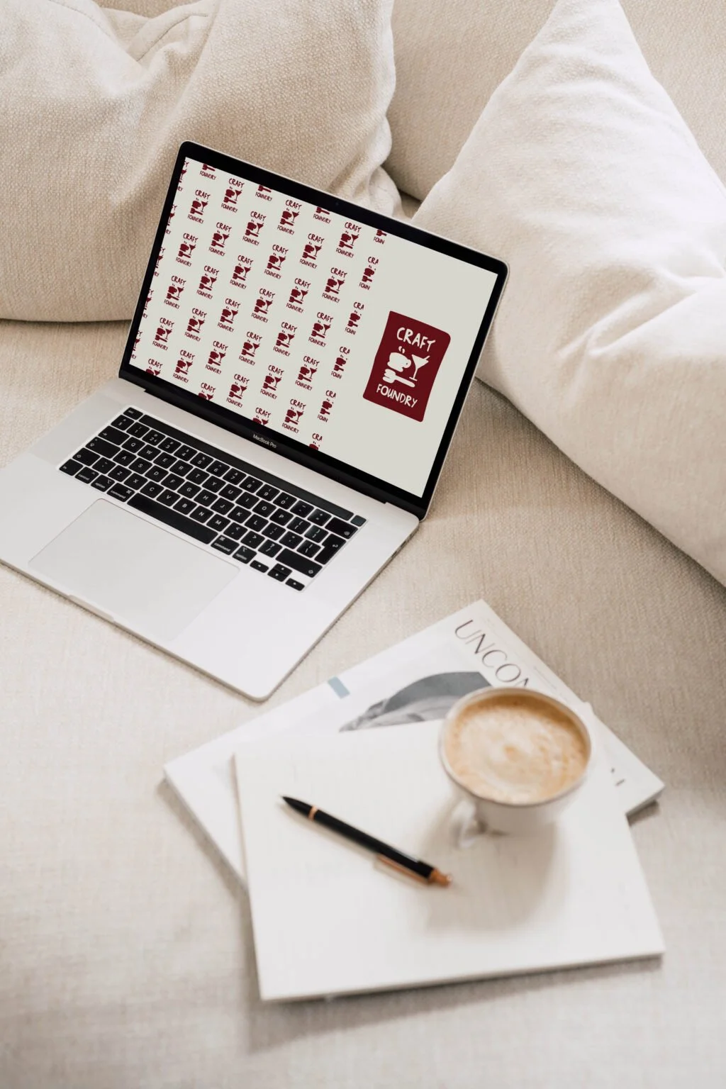 Craft Foundry logo and pattern displayed on a laptop for a creative business.
