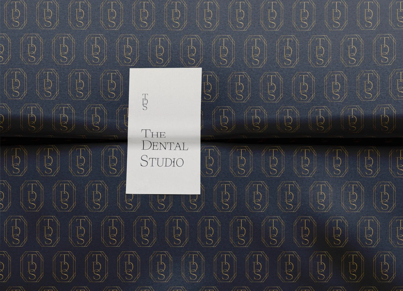 Minimalist logo and branded pattern for The Dental Studio.