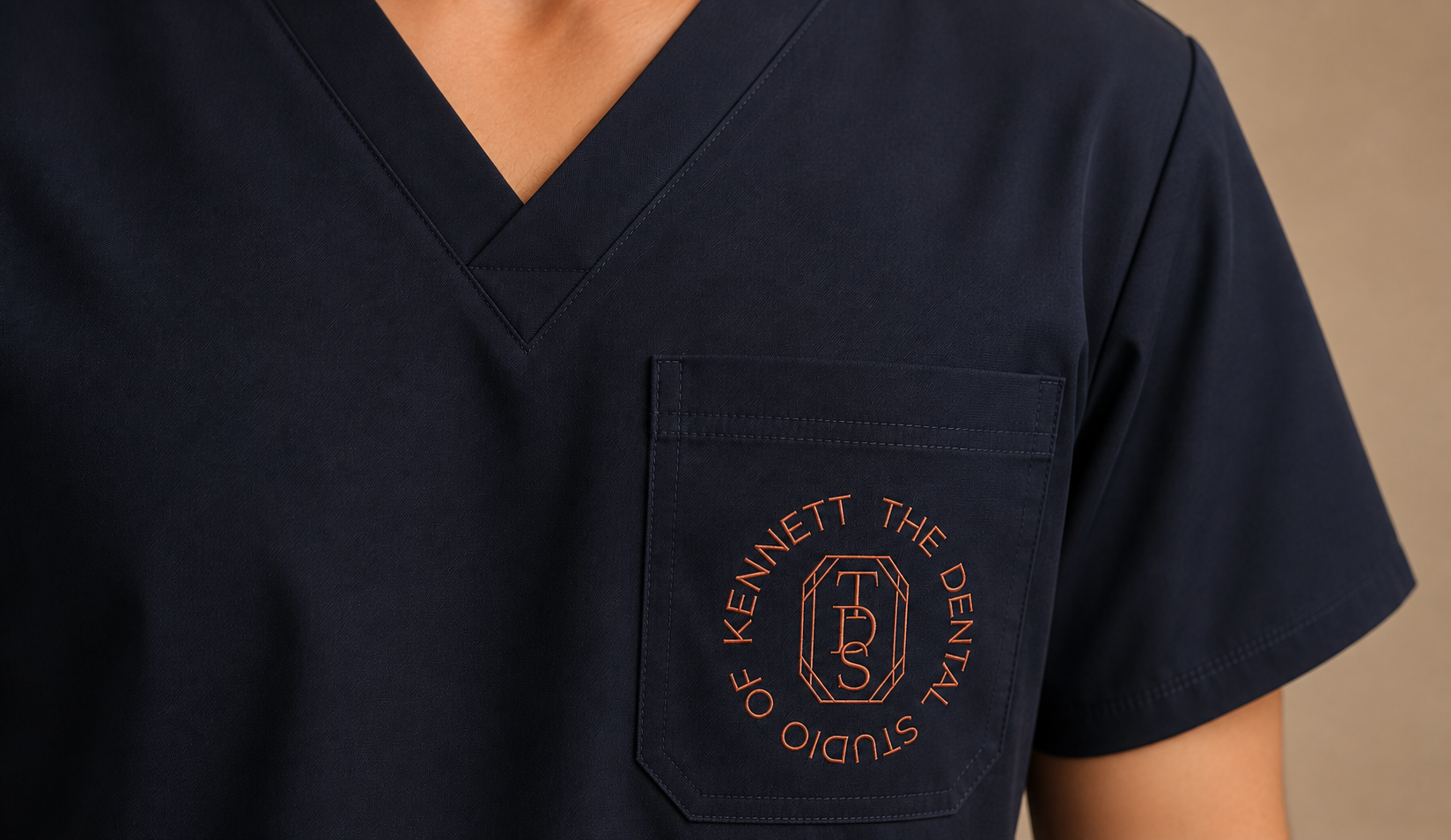 Employee wearing scrubs with an embroidered dentist logo