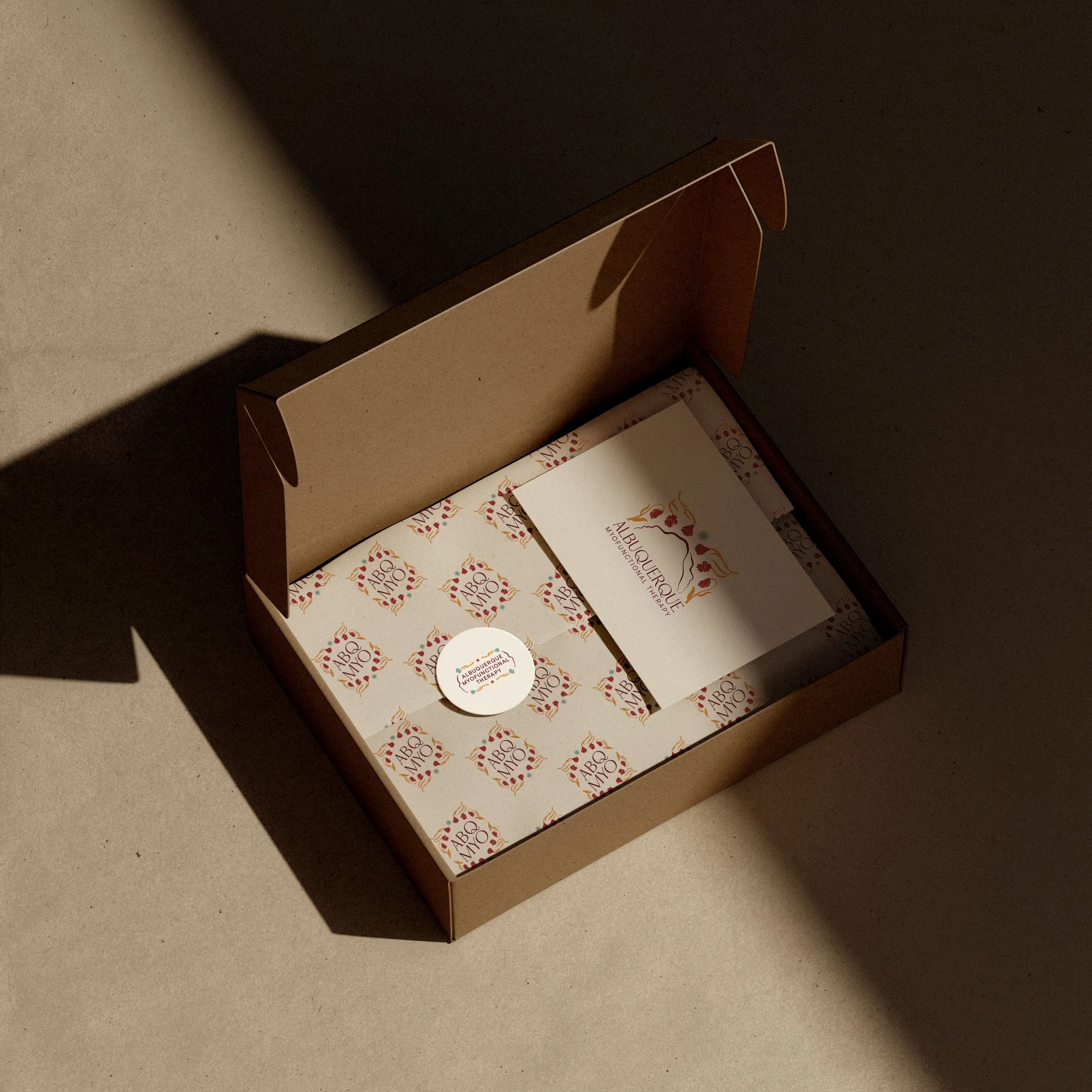 Branded items for a myofunctional therapist arranged in a box