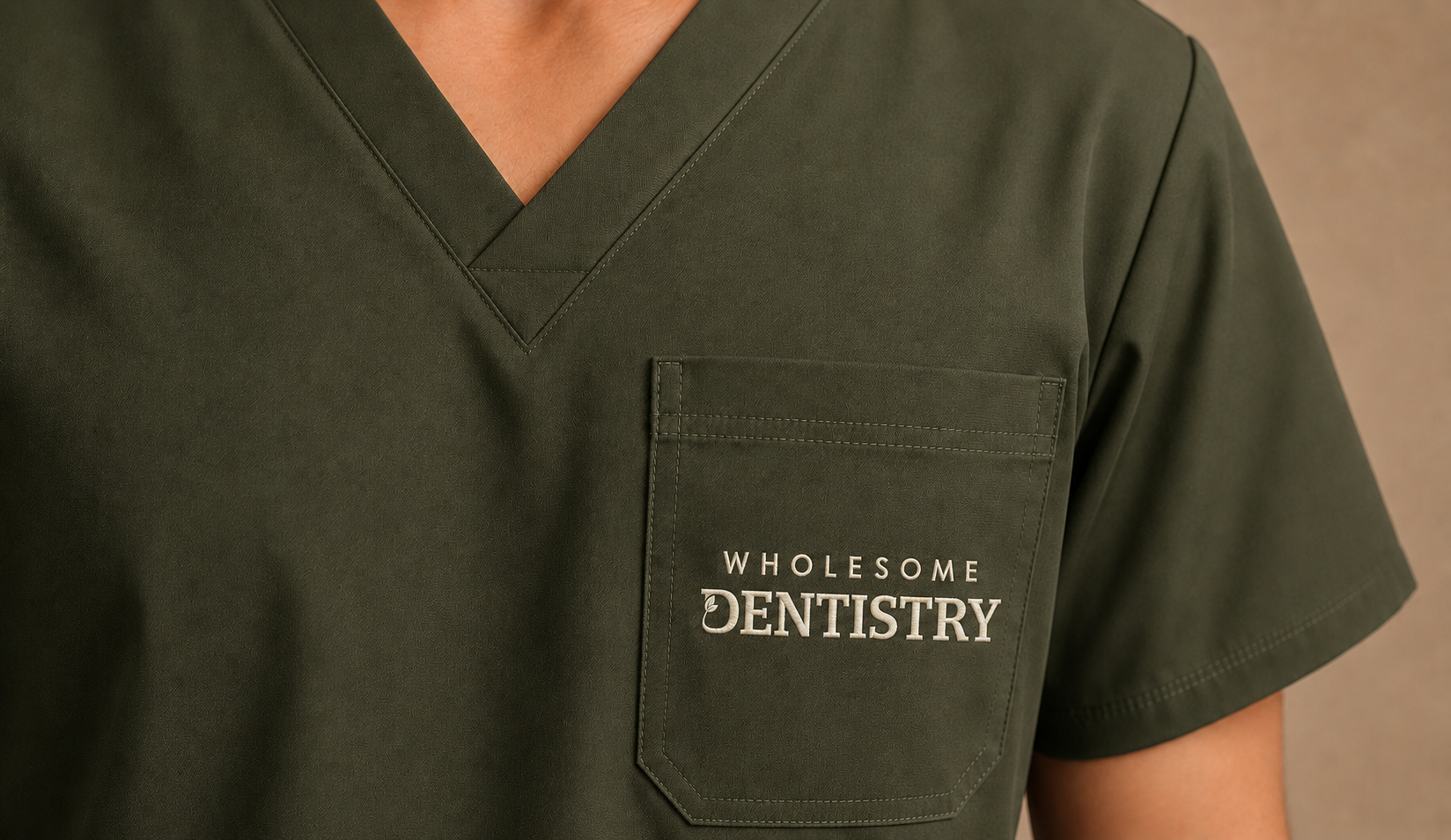 ist logo embroidered in a practioner scrub Dental practice logo embroidered on a practitioner’s scrubs.