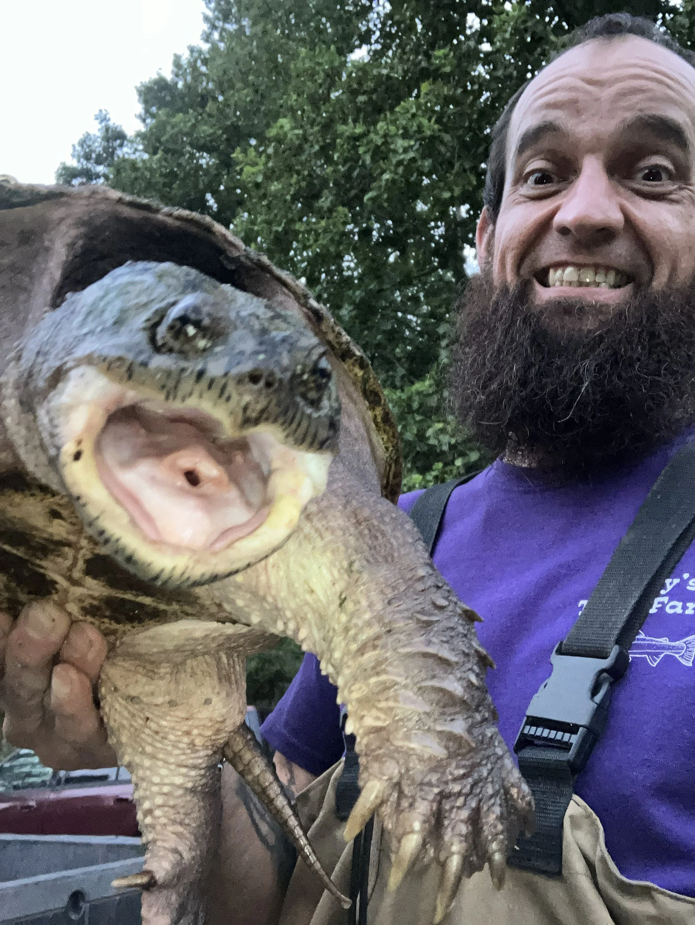 Enjoying an unexpected encounter with a native turtle while working on the farm.