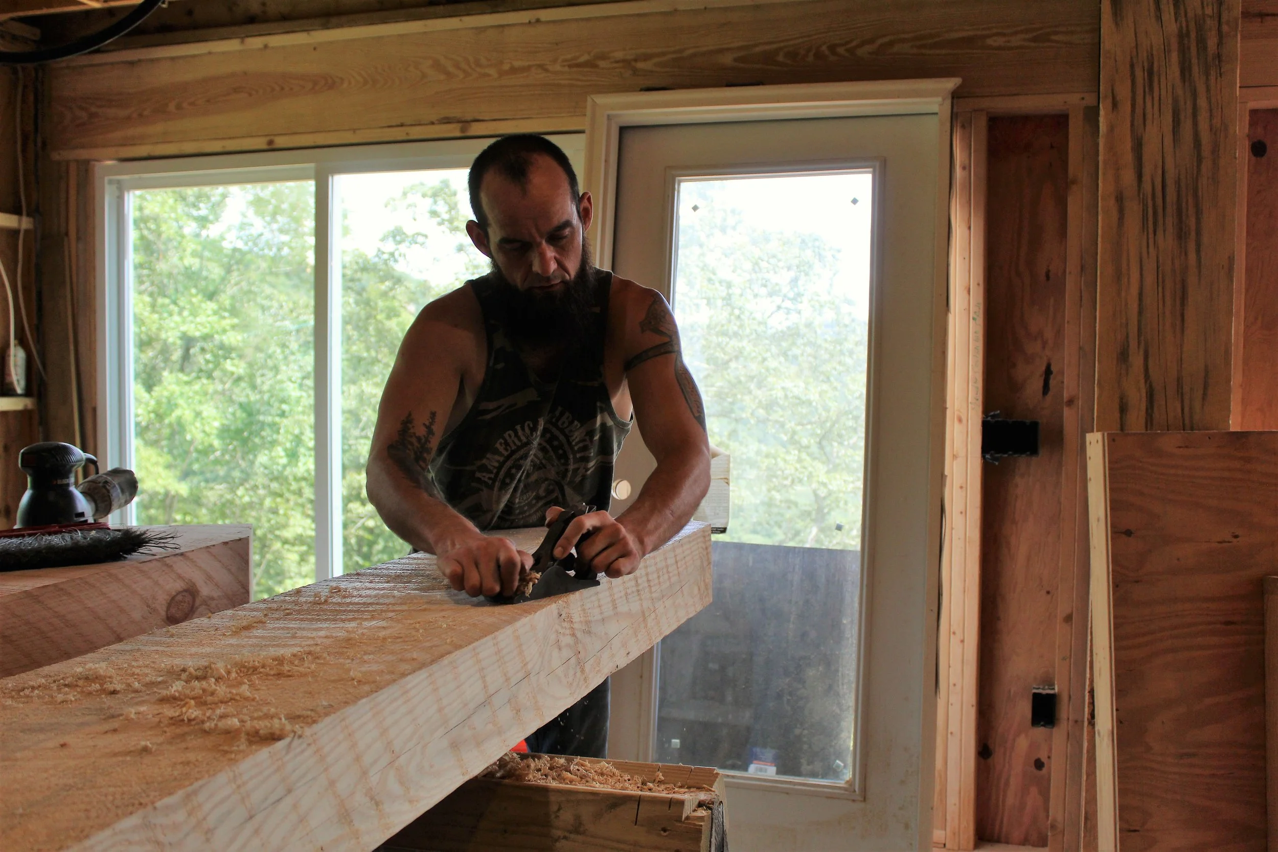 Shaping wood by hand with traditional tools, reflecting the care and craftsmanship behind every project.