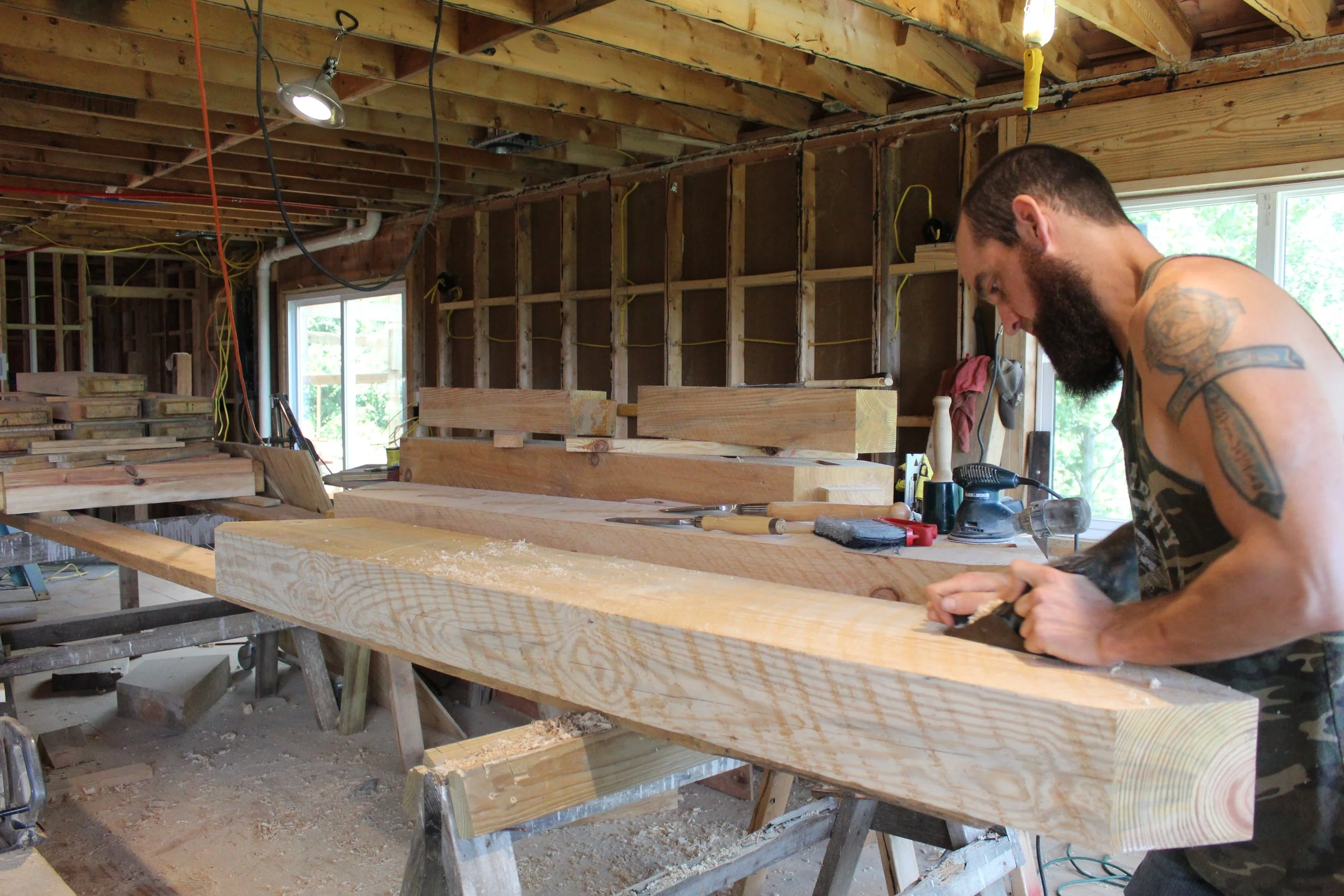 Hand planing a staircase stringer using traditional woodworking techniques for a custom-built staircase.