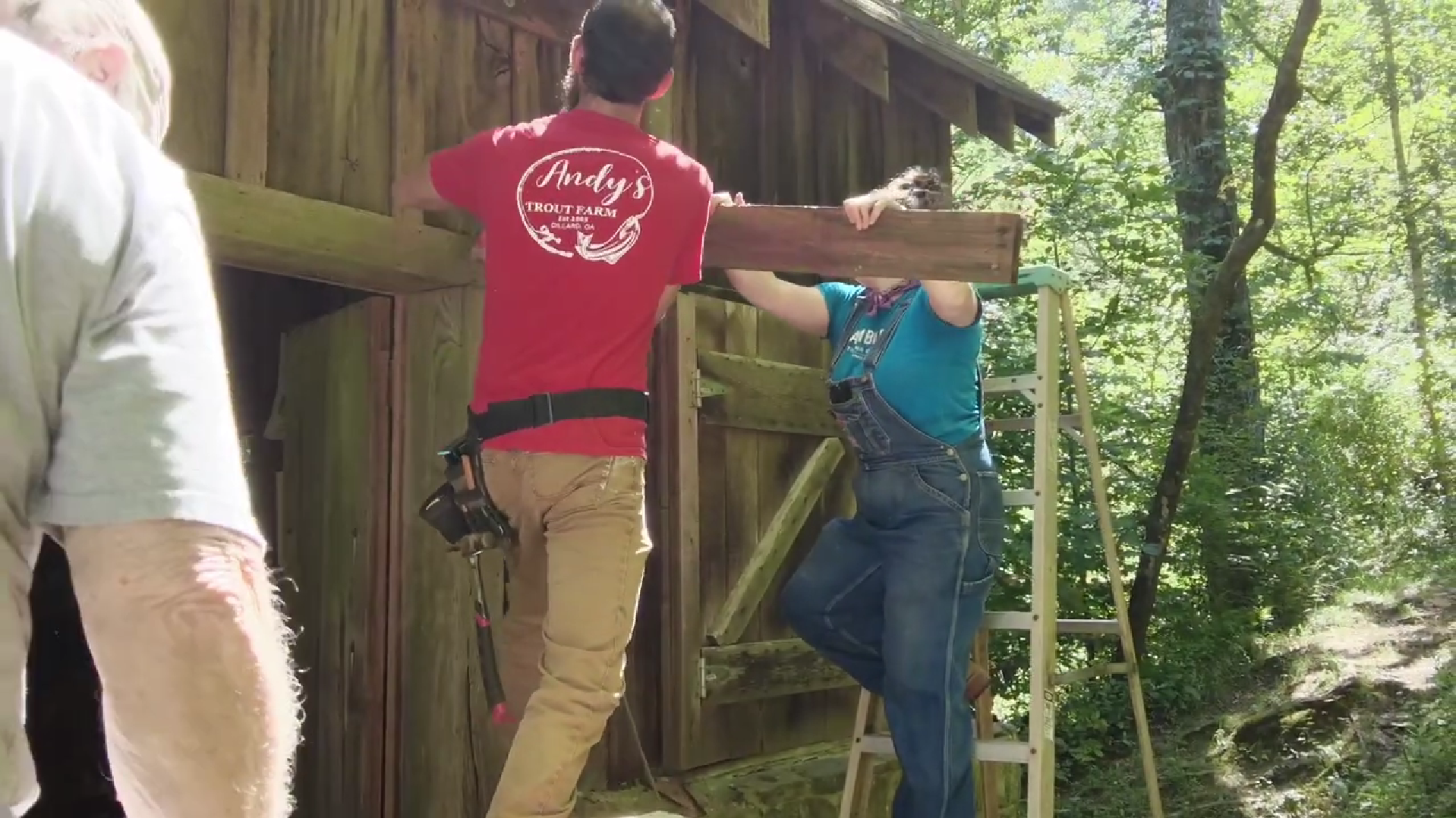 Team members dismantling the original awning to prepare for restoration work at Barker's Creek Mill.