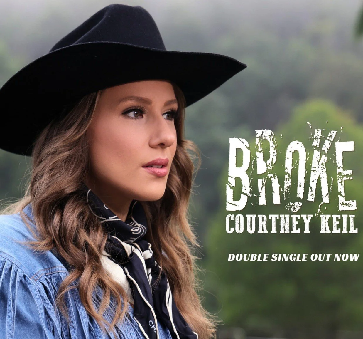 Cover art of Courtney Keil's single titled "Broke" featuring a woman with long wavy hair wearing a black hat and bandana, outdoors with a blurred green background. The text overlays the image, indicating the single is out now.