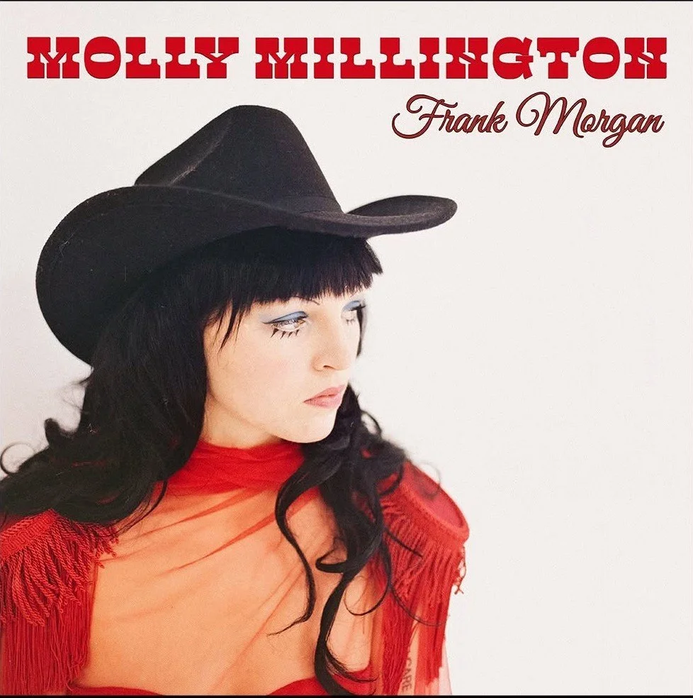 Album cover of Molly Millington with a woman wearing a black cowboy hat, red fringe top, and dark hair, looking to the side.