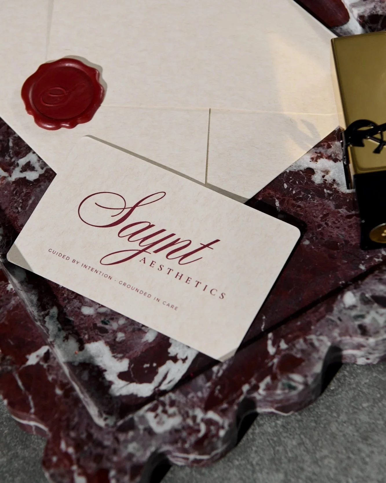 Saynt Aesthetics luxury clinic stationery featuring the Guided by Intention, Grounded in Care philosophy.