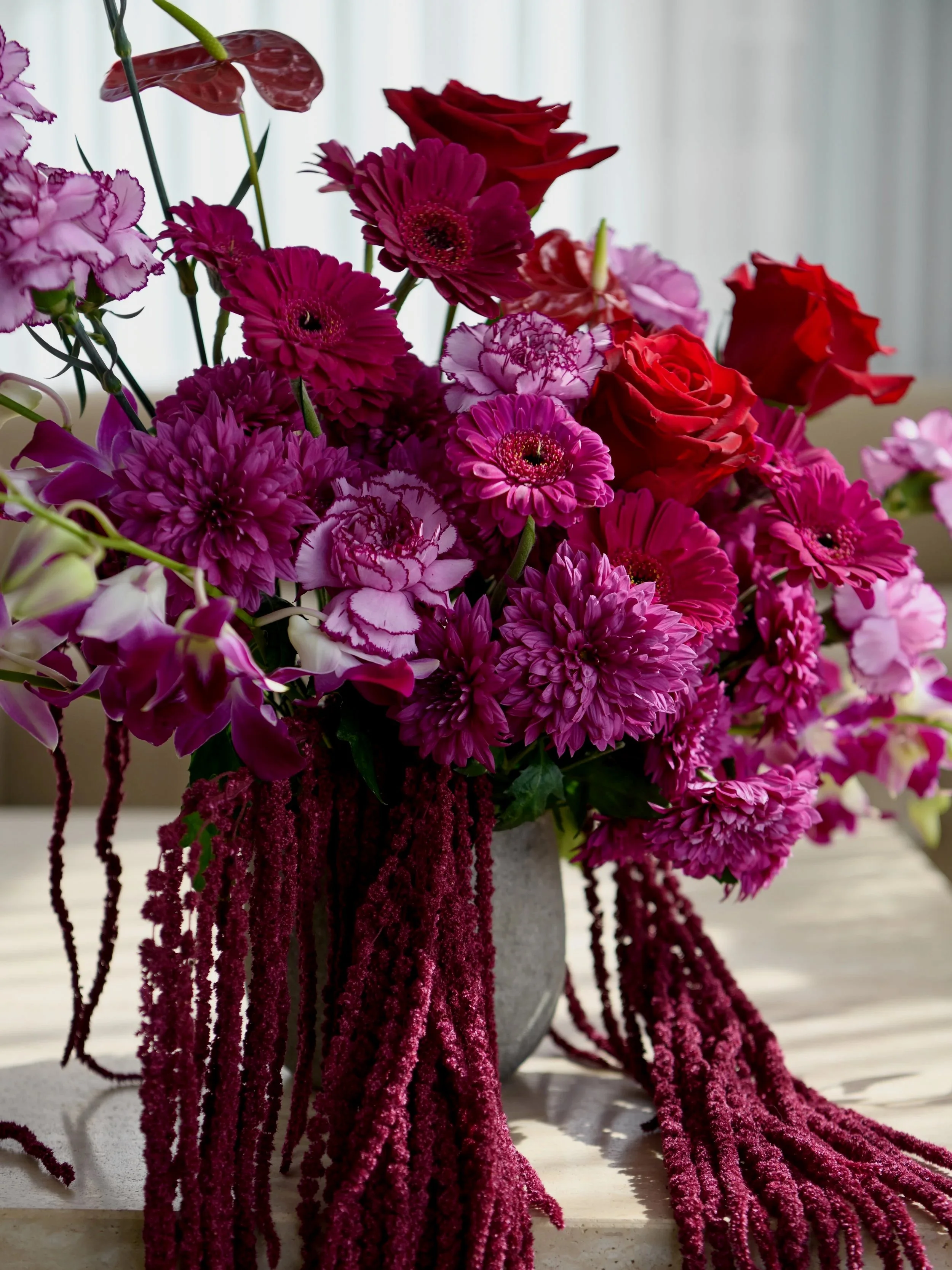 Burgundy and blush floral arrangement inside Saynt Aesthetics in West Leederville, Perth.