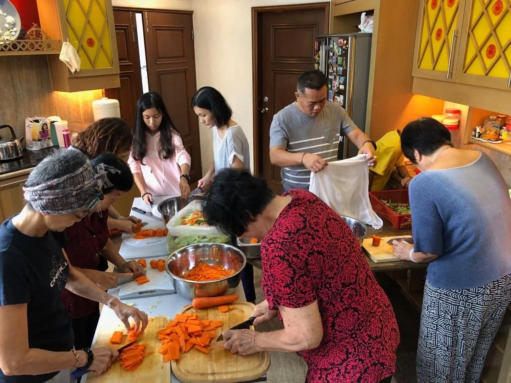 Volunteers preparing vegetables for a Malaysian school carnival Acar fundraiser.
