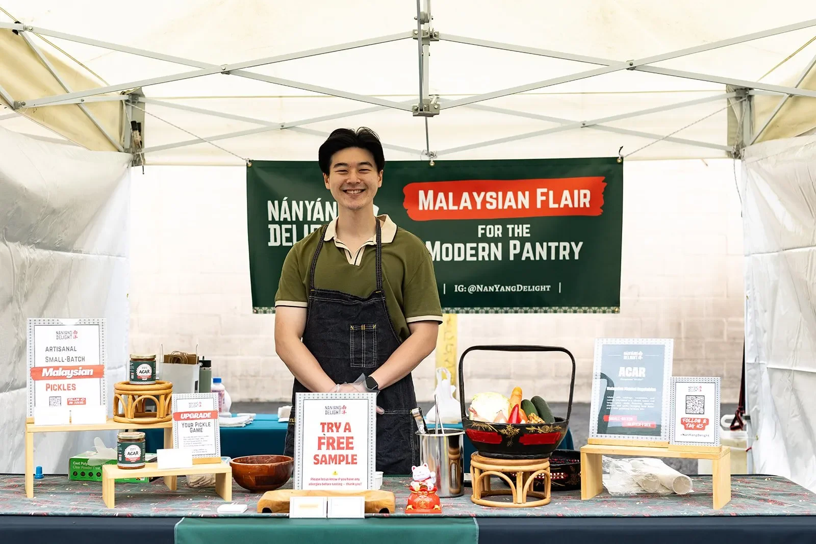 Liang Lim at the Nan Yang market booth displaying handcrafted Malaysian Acar.