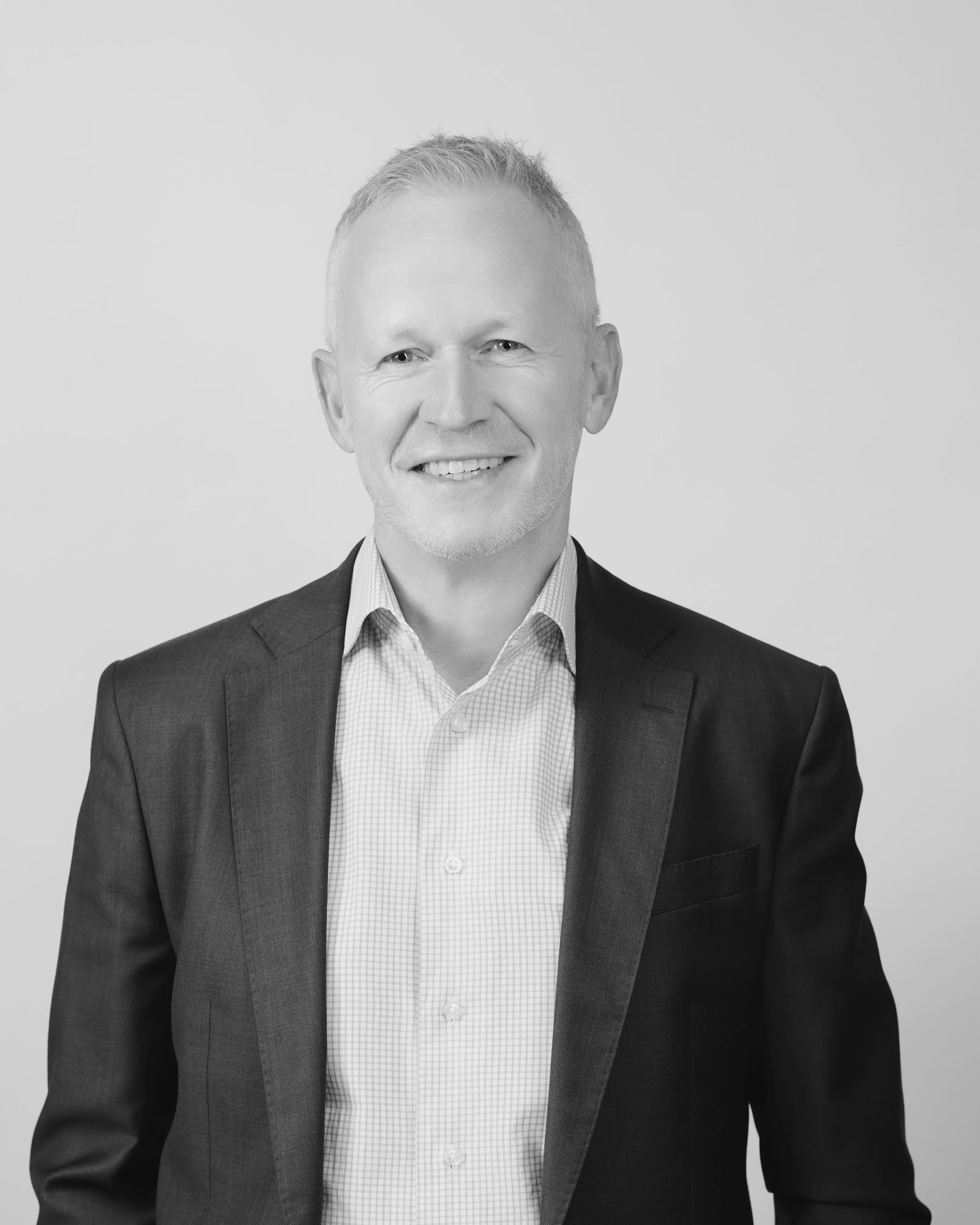 Gorden Thoms, Partner at Oreana Advice Partners in a suit and dress shirt, facing the camera, against a plain background.