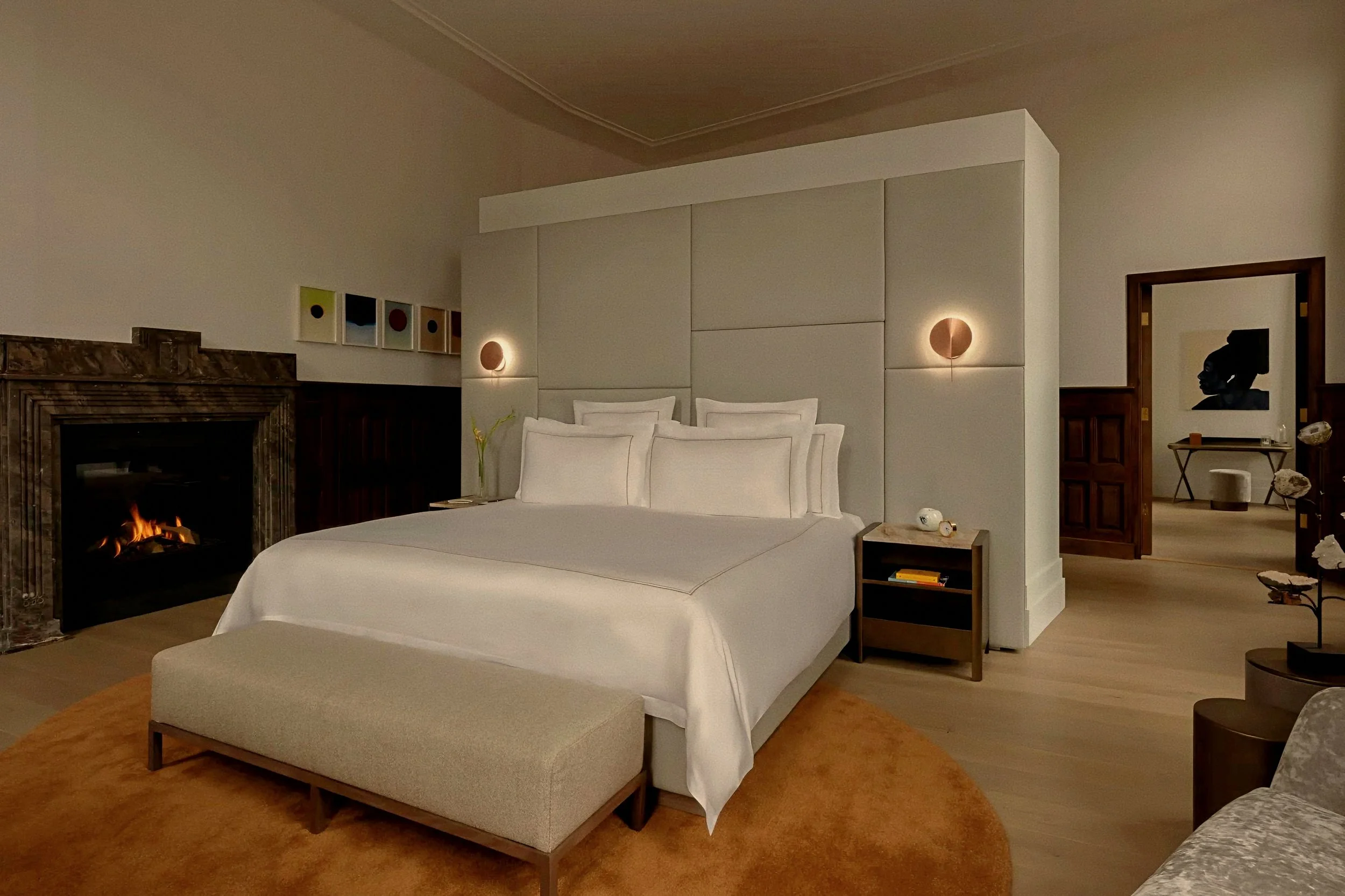 Upholstered bed partition and marble fireplace hearth at Rosewood Amsterdam a luxury hotel in Netherlands.