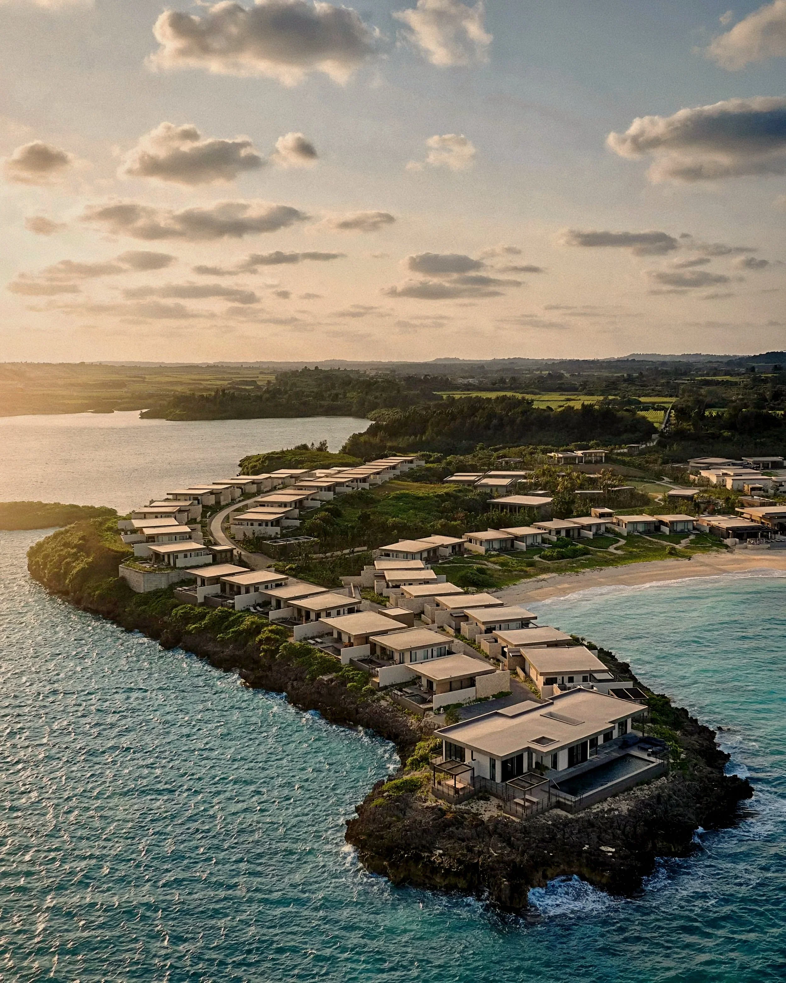 Aerial view of luxury villas at Rosewood Miyakojima resort in Okinawa, Japan, on the Ryukyu Islands coastline.