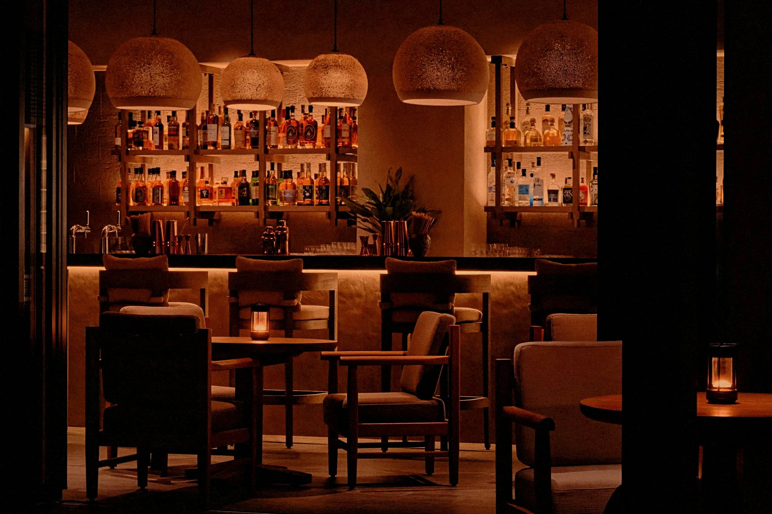 Moody luxury cocktail bar at Rosewood Miyakojima resort in Okinawa, Japan, along the Ryukyu Islands coast.