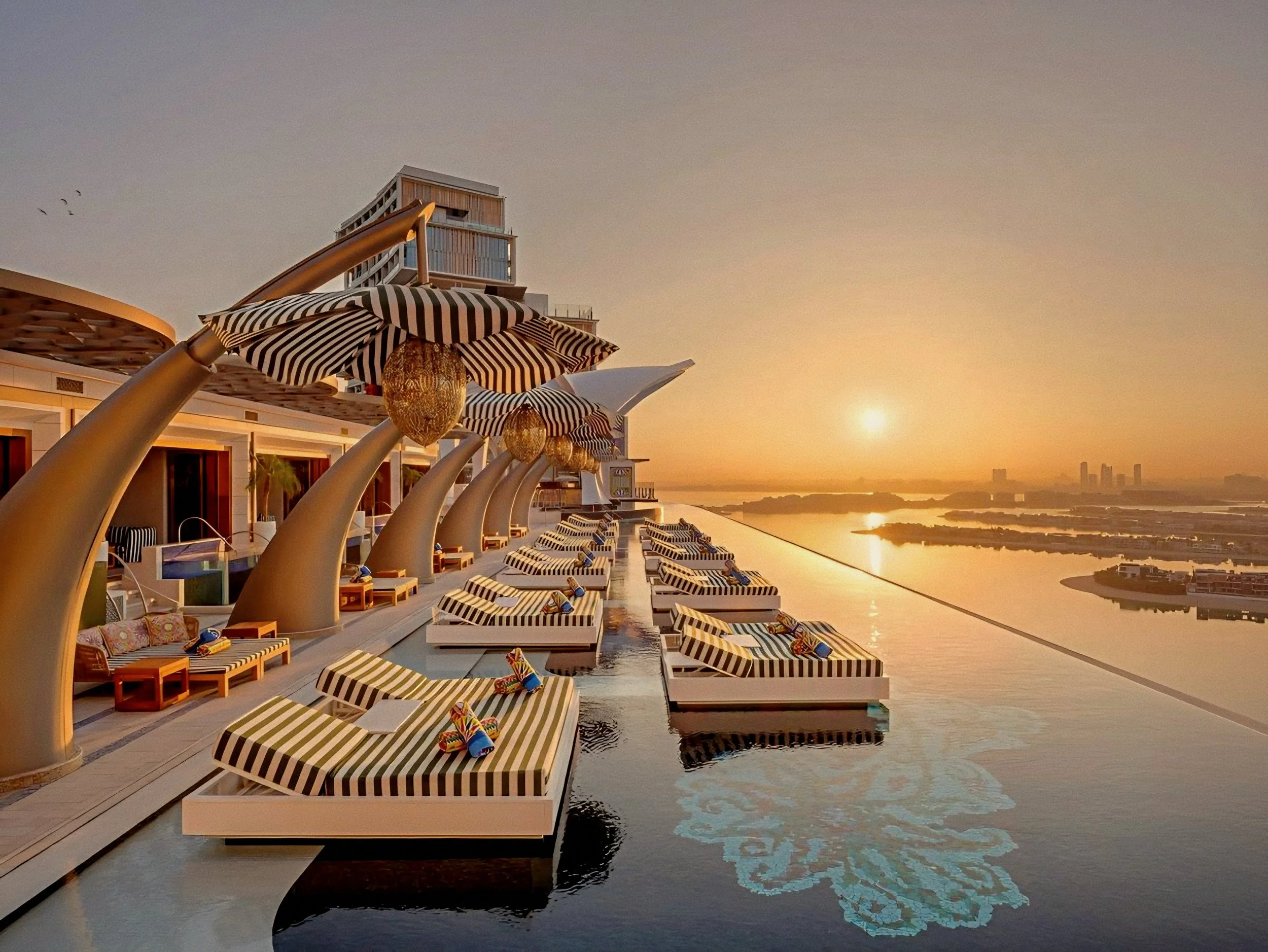 Cloud 22 rooftop infinity pool with striped loungers at Atlantis The Royal luxury beach resort palm jumeirah dubai