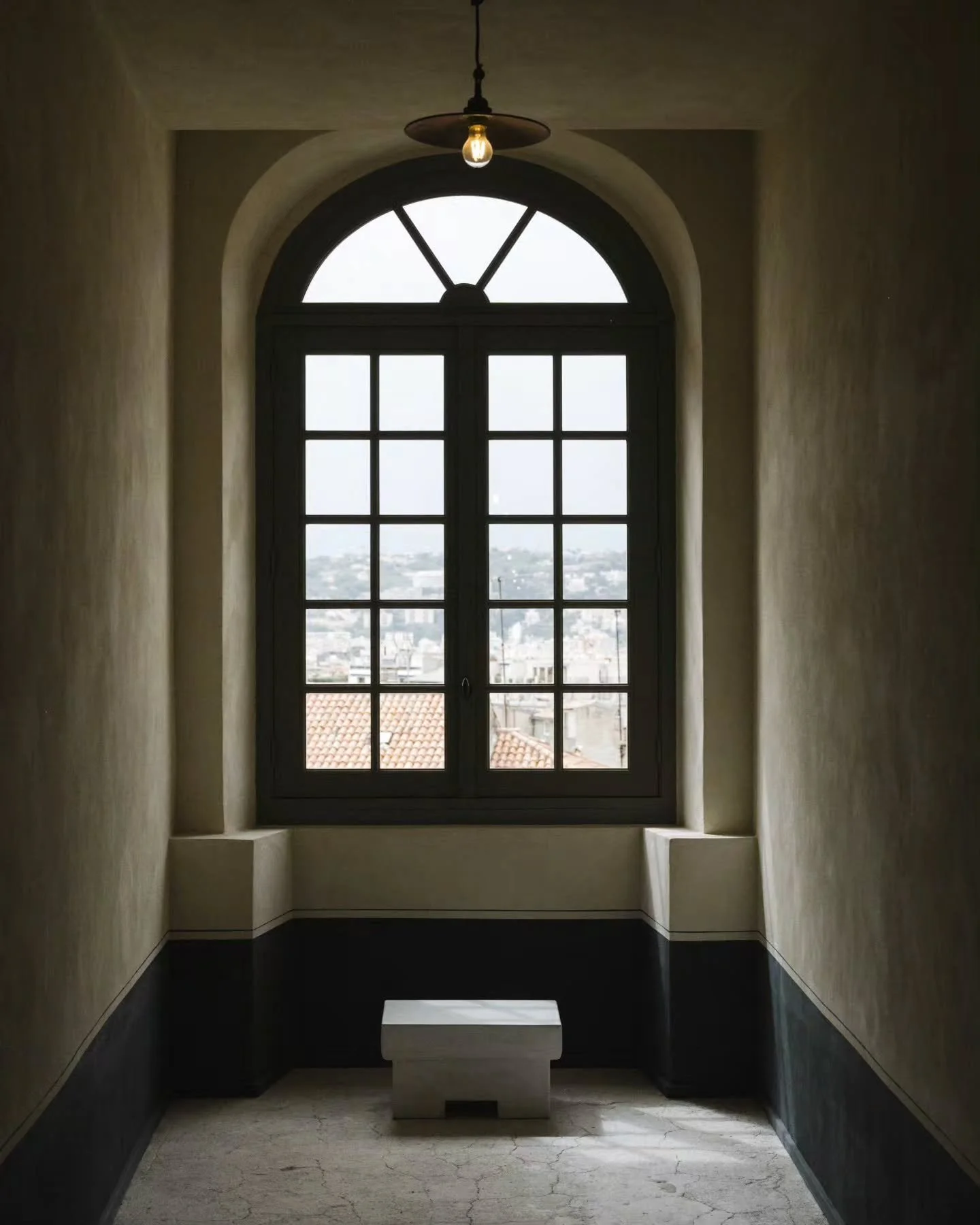 Monastic austerity defined by raw materiality&mdash;where hand-troweled lime wash, a charcoal-painted baseboard, and a low stone plinth align beneath a dramatic arched casement window. 

​Interior Design by Festen Architecture.

​The Corridor at @hot