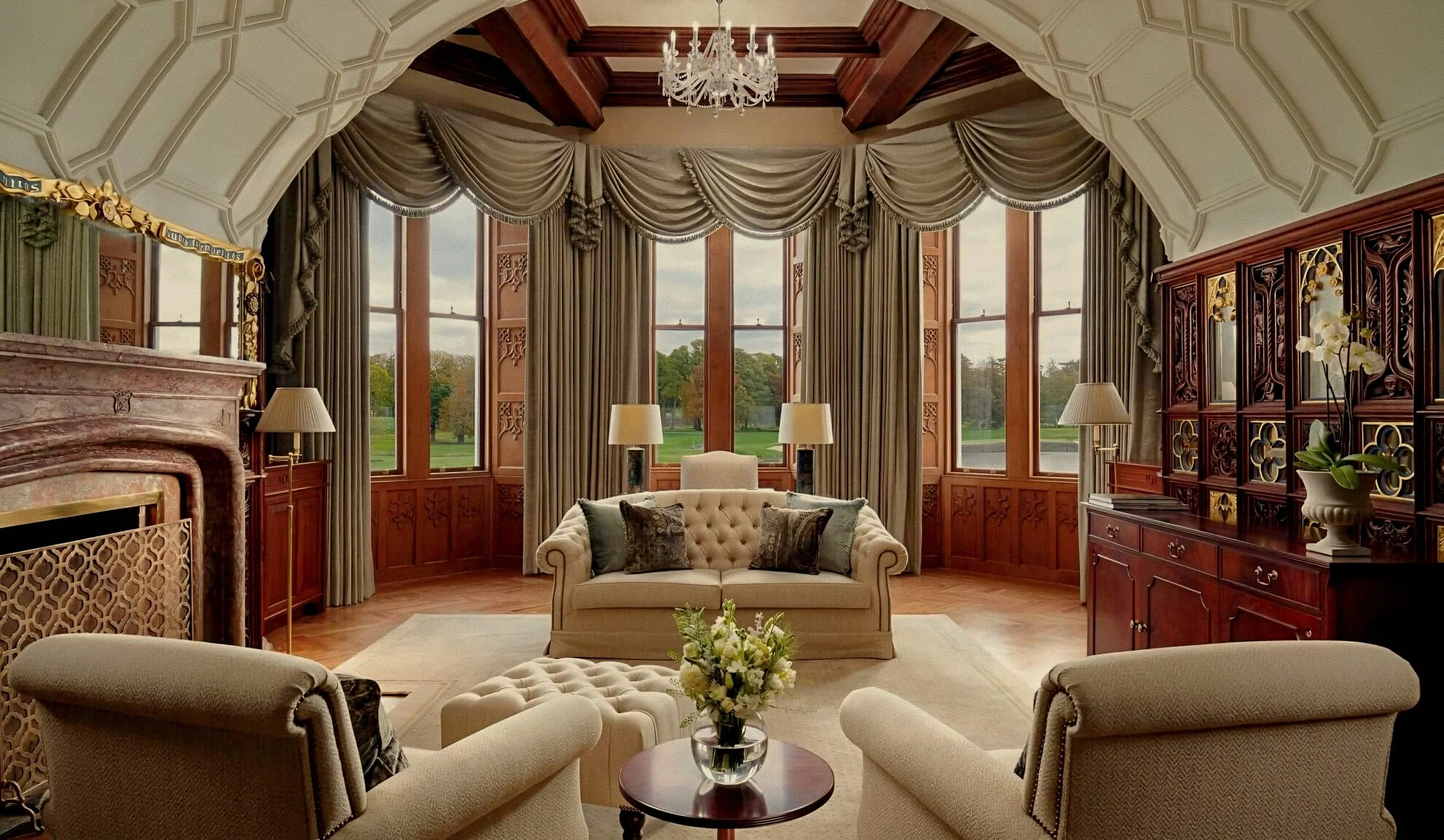Ribbed vaulted ceiling and tufted sofas in living room at Adare Manor luxury hotel in Ireland.