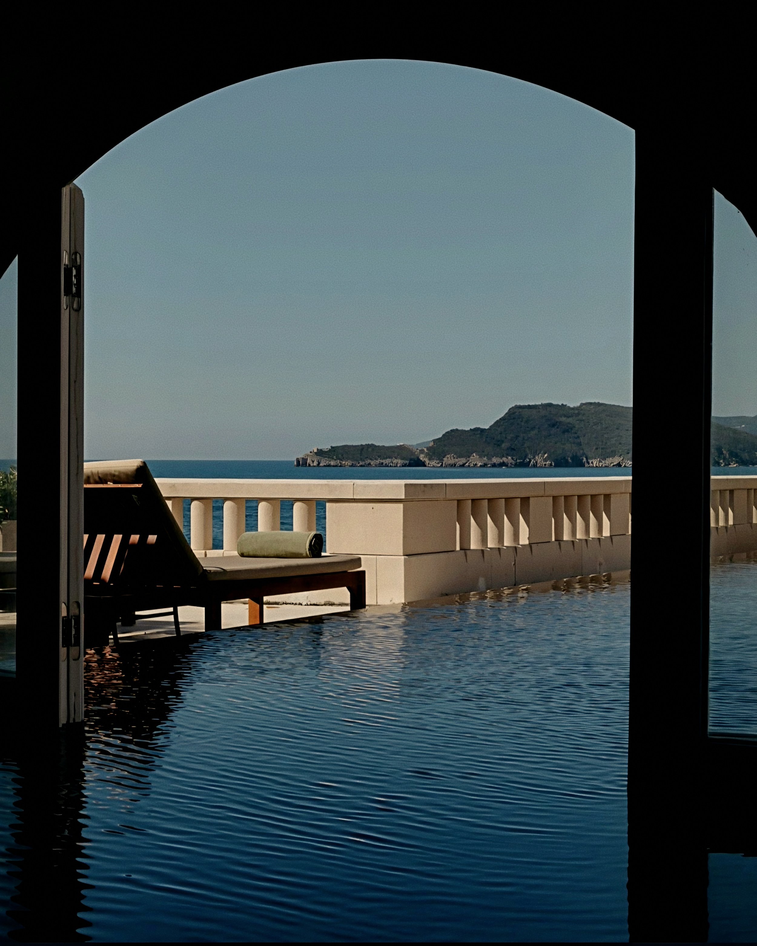 Stone balustrade and cliffside lap pool terrace Aman Sveti Stefan Luxury Resort in Montenegro.