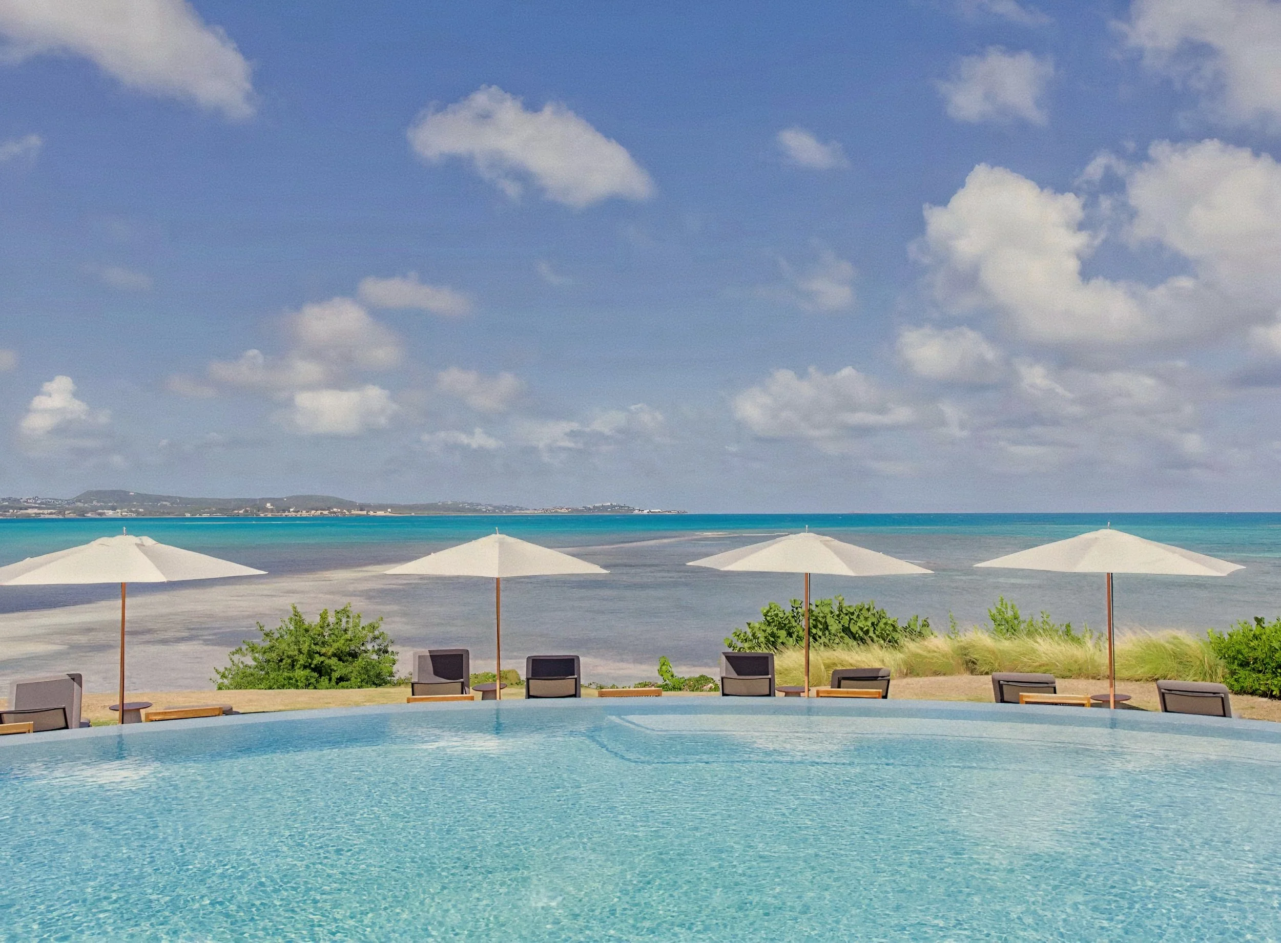 Infinity pool overlooking the Caribbean sea at Jumby Bay luxury private island, Antigua.