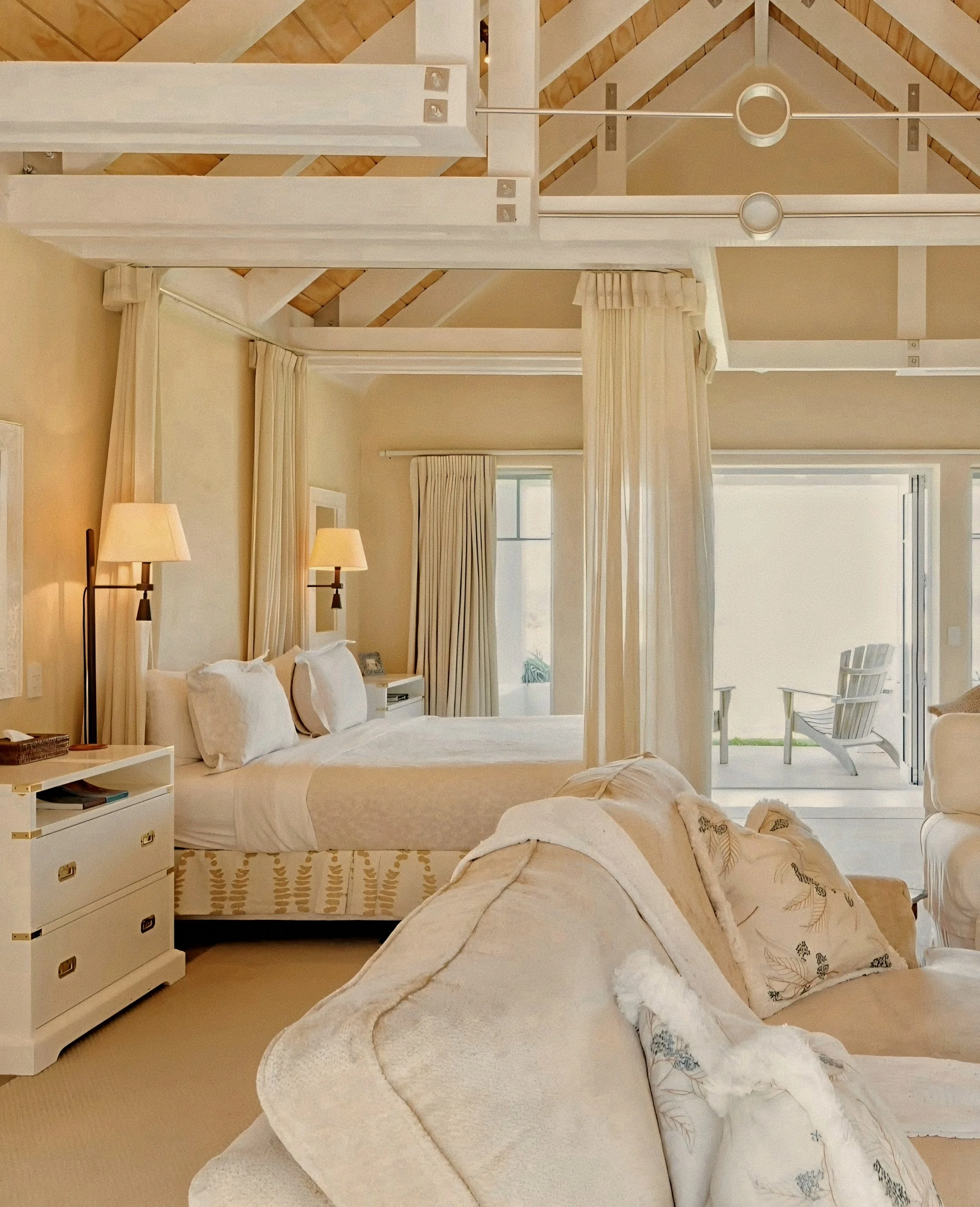 Luxury cottage suite with canopy bed draped in woven linen by Virginia Fisher at Wharekauhau Country Estate, New Zealand.