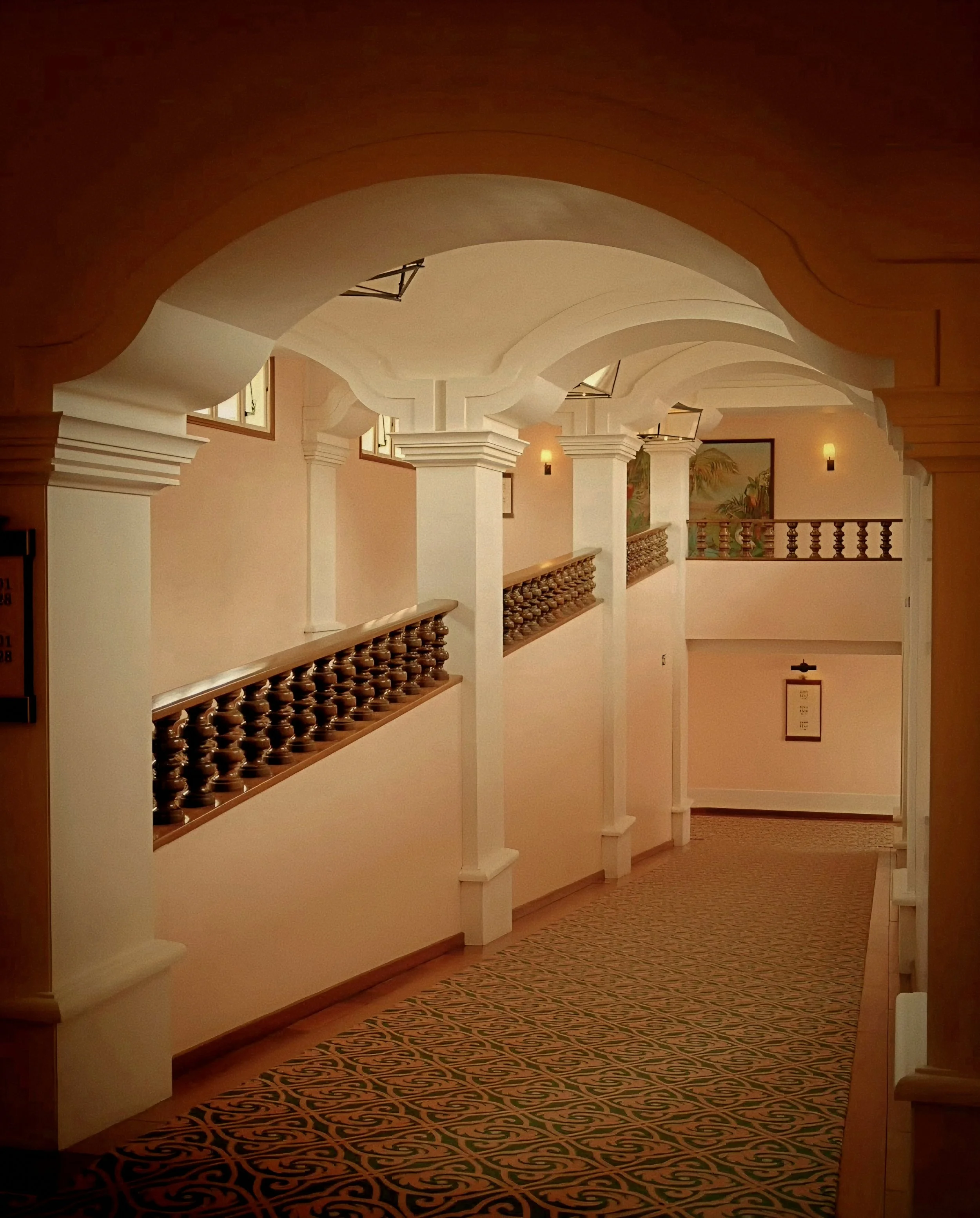 Whitewashed colonial archway corridor at Hotel das Cataratas Belmond in Iguassu Falls Brazil.