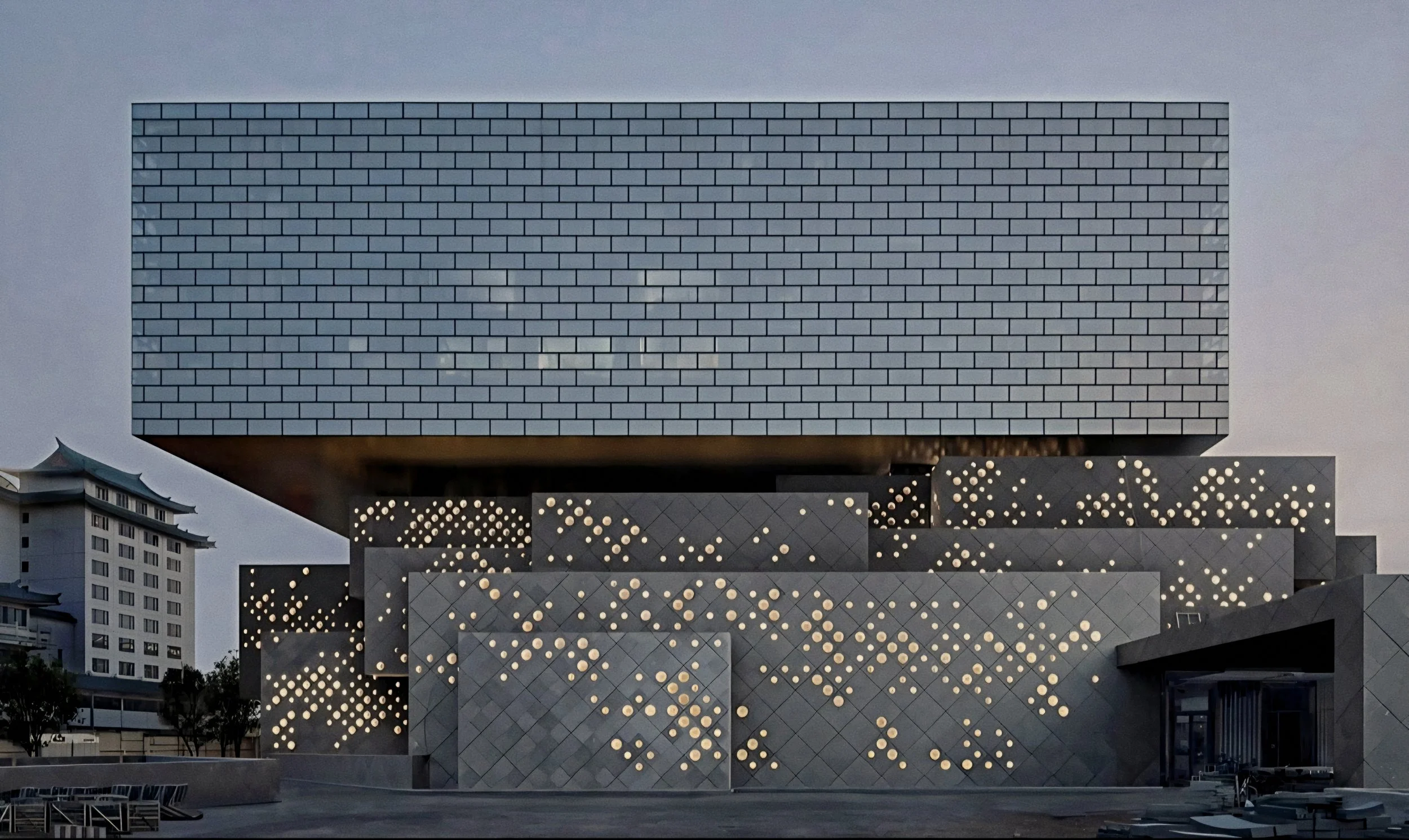 Perforated stone tile facade and glass brick crown At The PuXuan Hotel and Spa in Beijing, China.