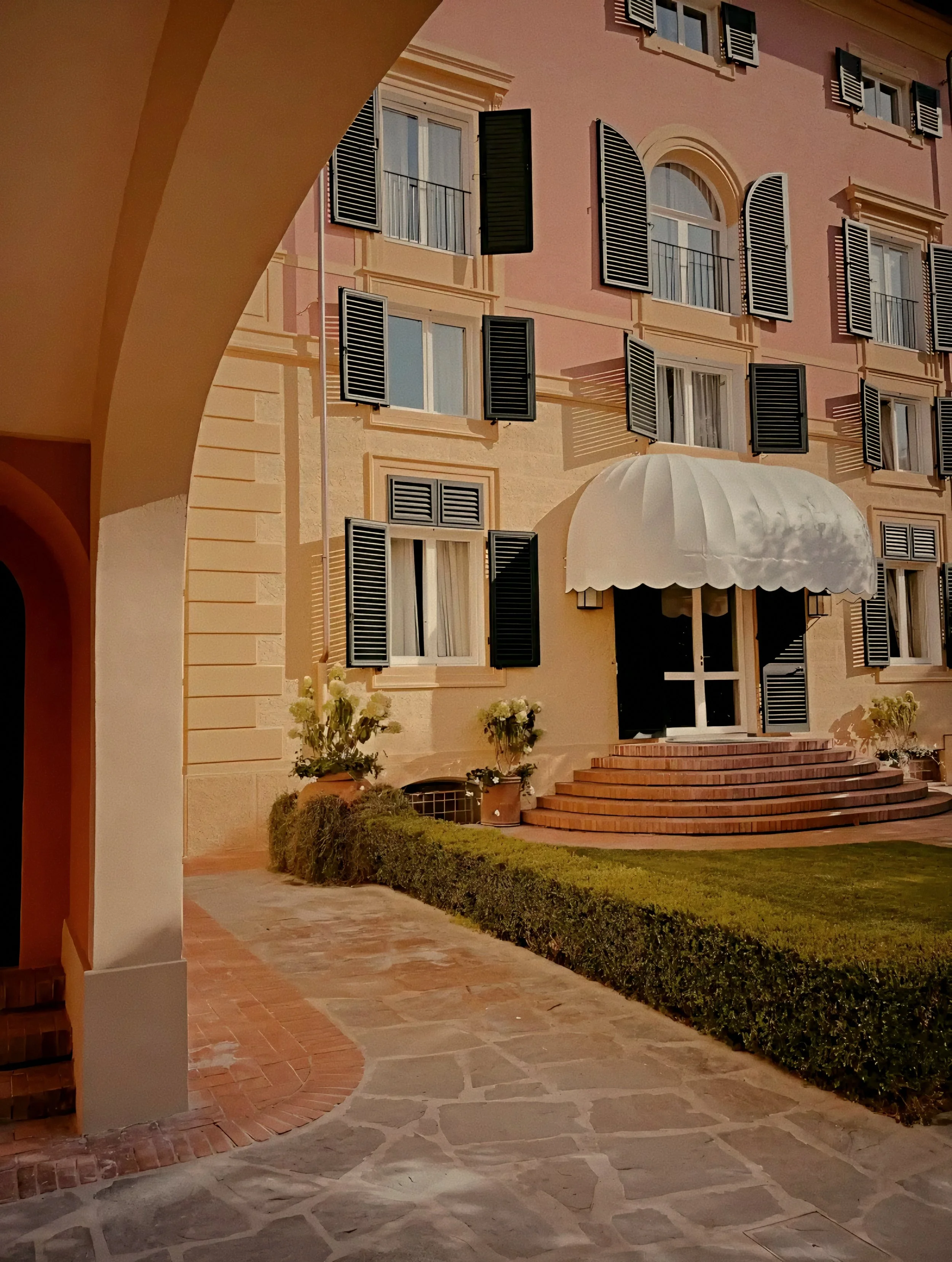 Terracotta façade of Augustus Hotel & Resort in Forte dei Marmi, former Tuscan seaside villa of the Agnelli family.