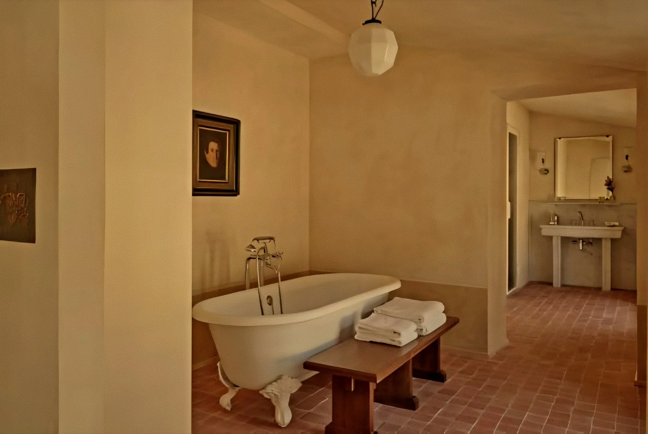 Clawfoot soaking tub and terracotta floor tiles at Hôtel du Couvent, a Luxury Collection Hotel, Nice, France.