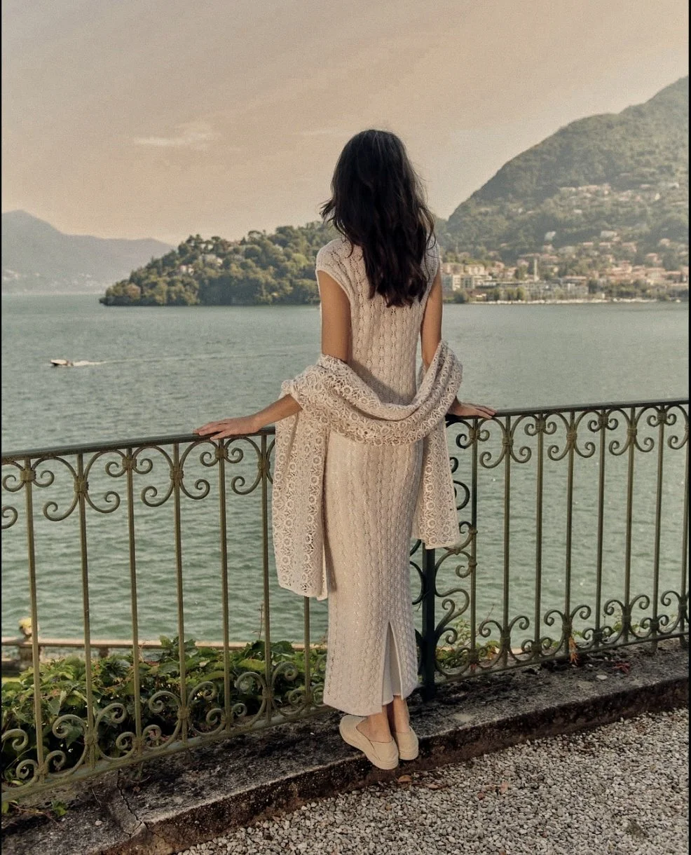Fine-knit cashmere gown by Lanificio Colombo on a balustraded terrace overlooking Lake Como, Italy.