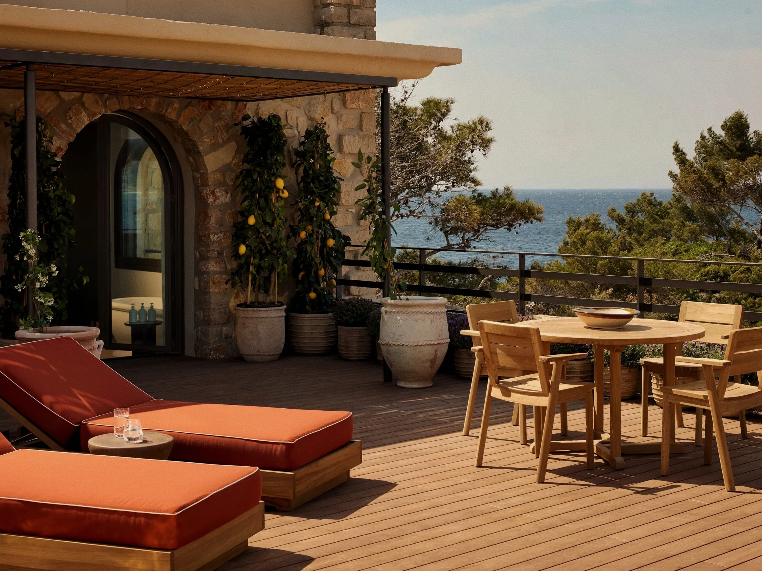 Terracotta oceanfront villa terrace with teak loungers at Zannier Île de Bendor, Provence.